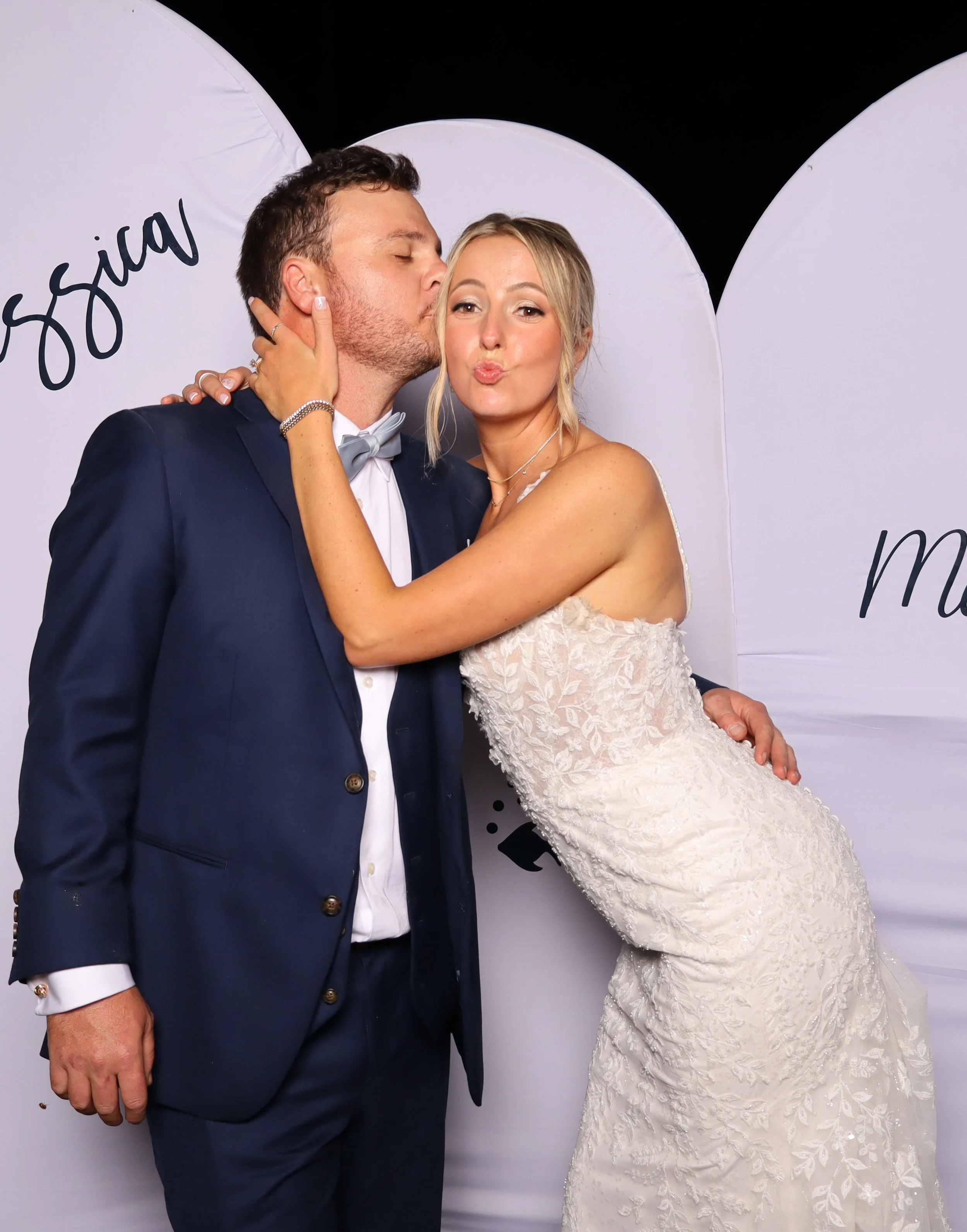 Bride and groom posing at premium wedding photo booth during Palm Beach reception