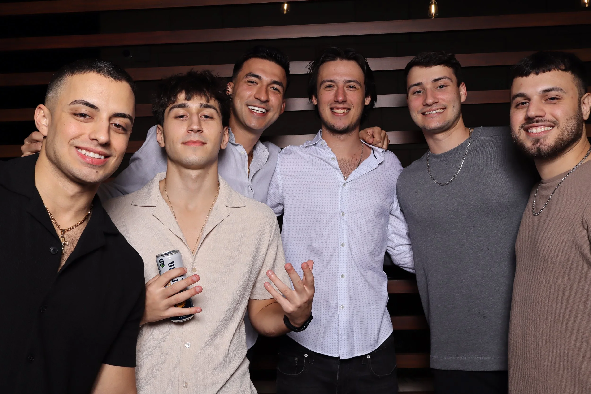 Luxury corporate Christmas photo booth experience at Life Time Fitness in Palm Beach Gardens with wooden wall backdrop and festive holiday props by AdCole Events