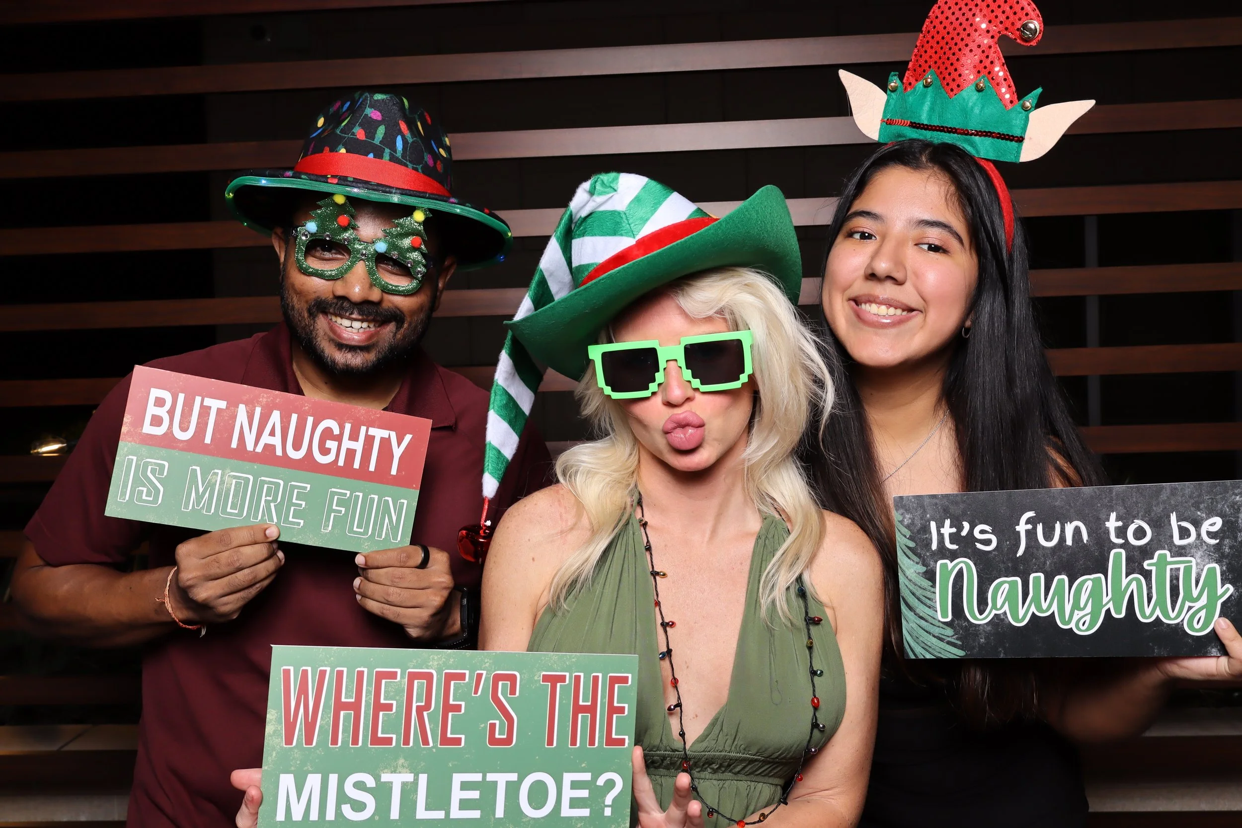 Luxury corporate Christmas photo booth experience at Life Time Fitness in Palm Beach Gardens with wooden wall backdrop and festive holiday props by AdCole Events