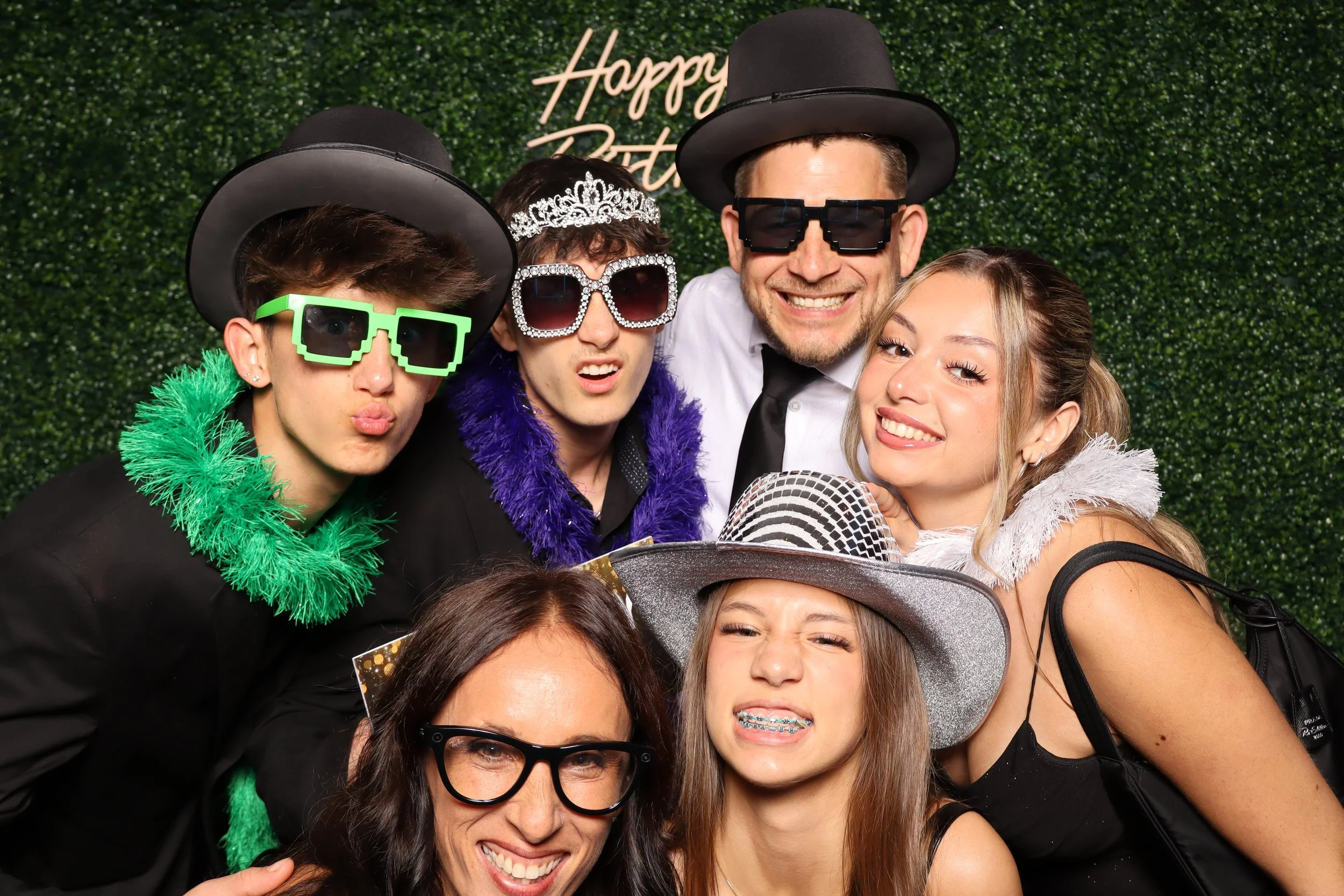 Luxury birthday photo booth experience with green hedge wall and “Happy Birthday” sign at Jacaranda Golf Club in Plantation, FL by AdCole Events