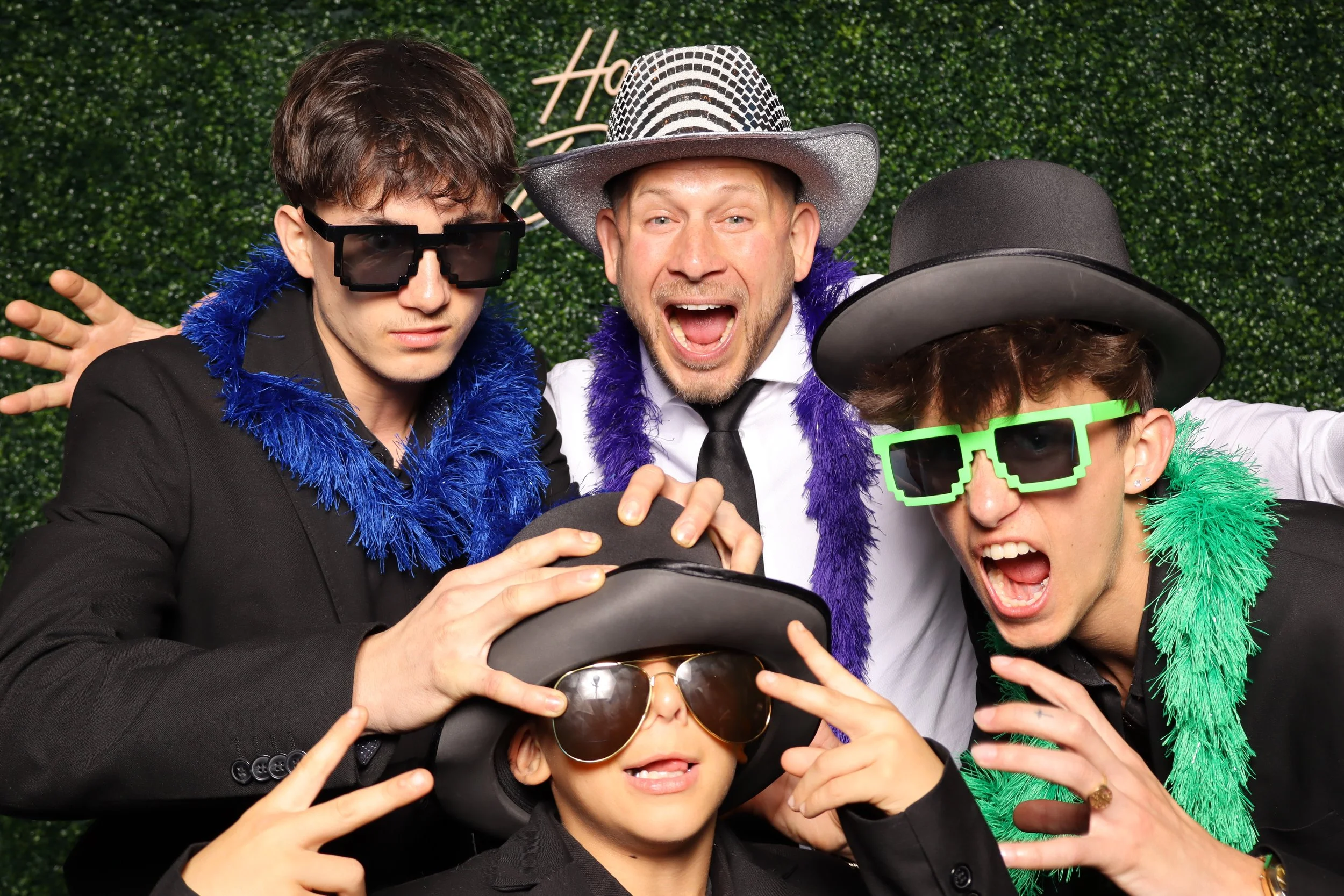 Plantation, FL birthday celebration photo booth with green hedge wall and “Happy Birthday” sign at Jacaranda Golf Club