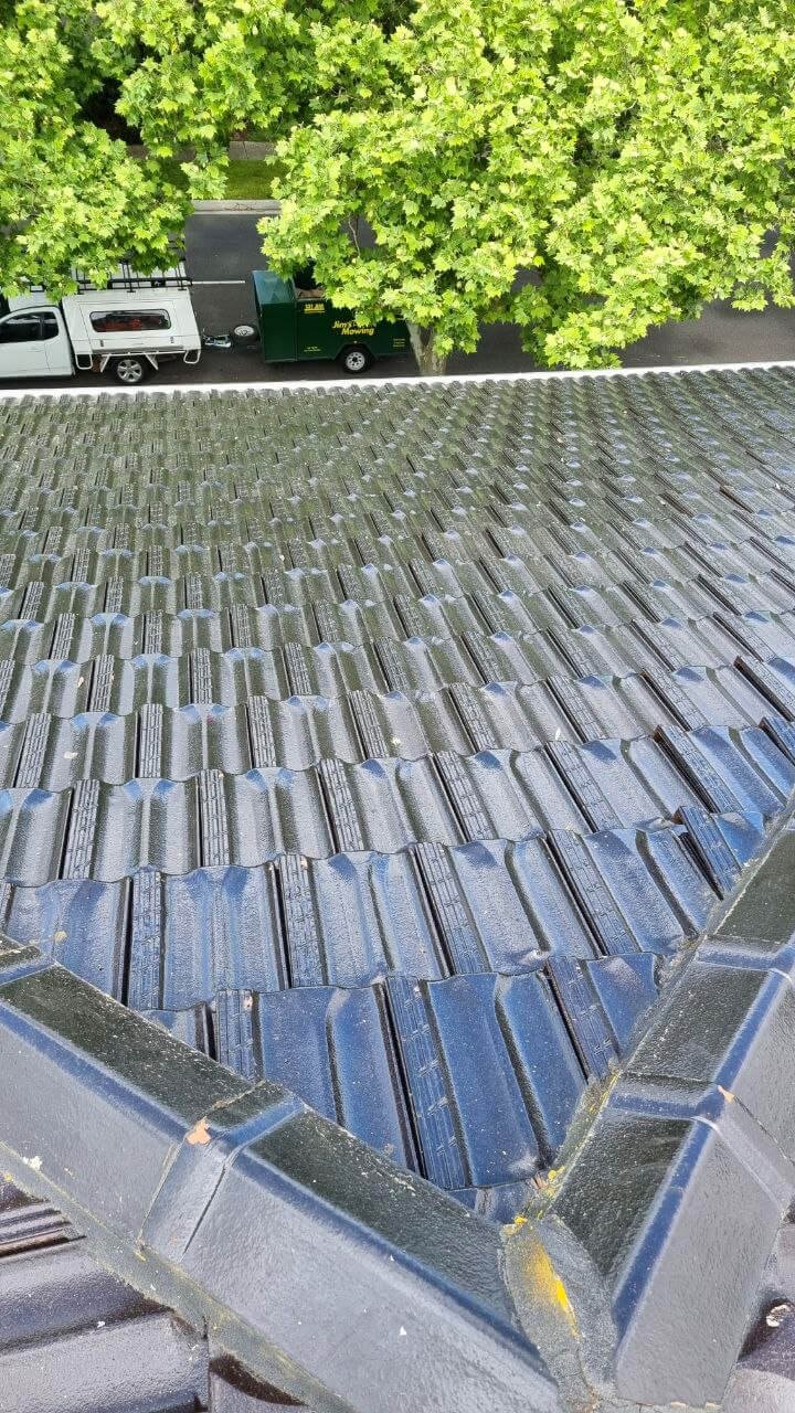 Oranssi technician working on a roof project