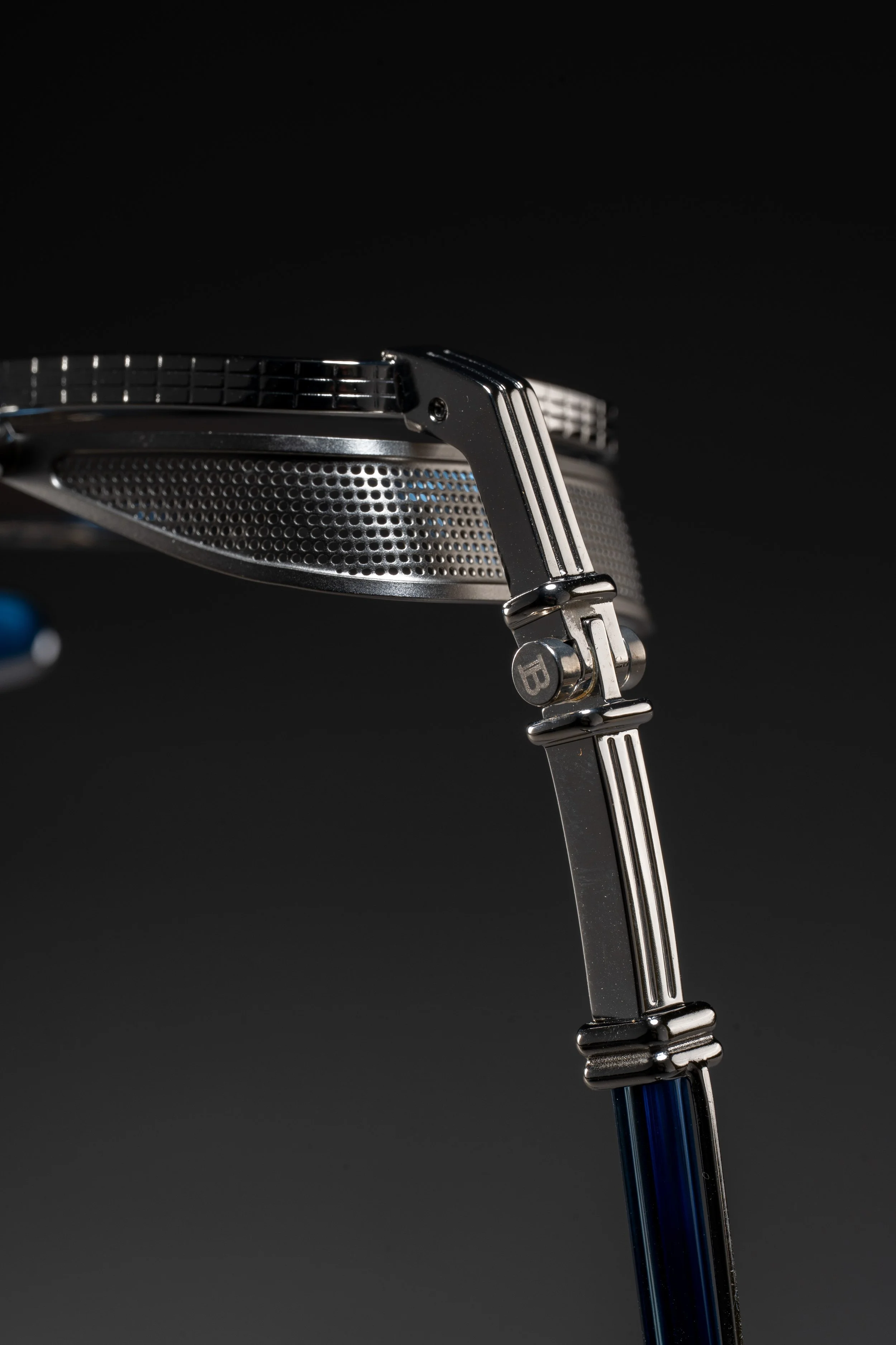 Close-up of a golf driver club head and shaft against a black background.