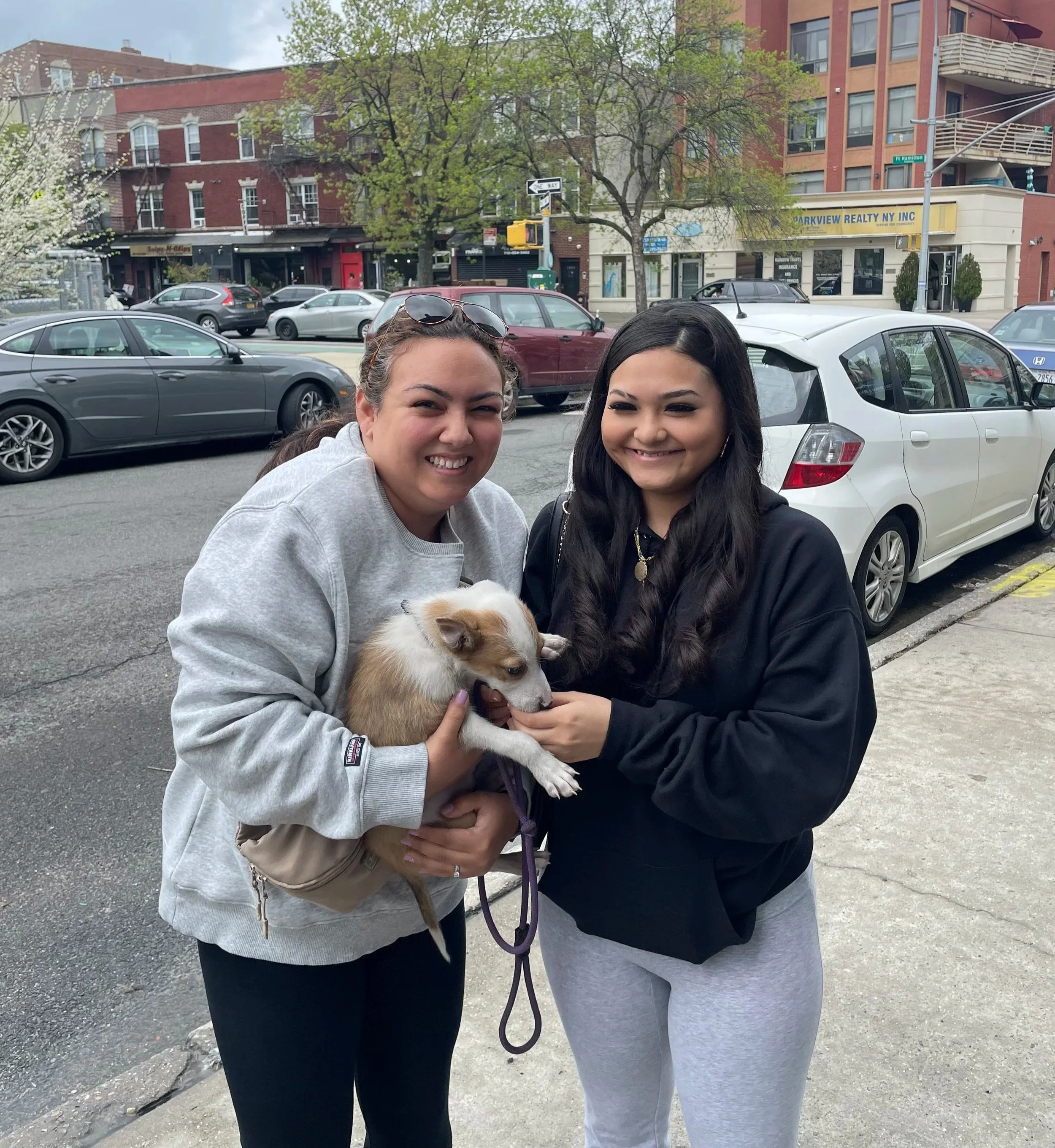 Two participants together outdoors with a dog