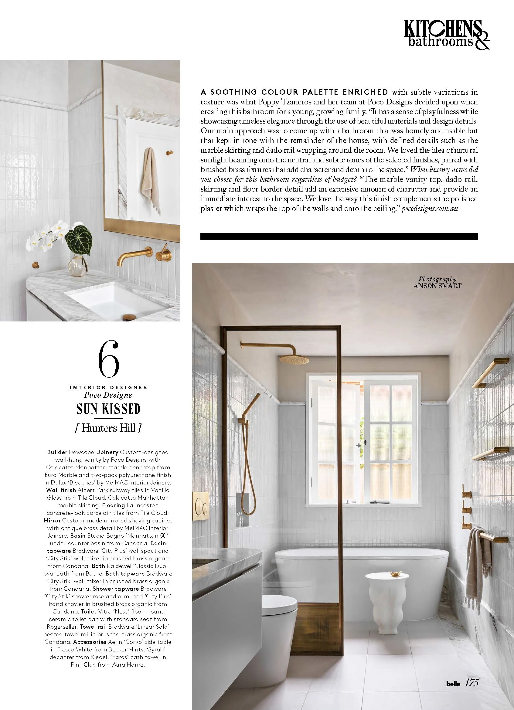 A modern, white bathroom with a bathtub, a large window, and gold fixtures, including a showerhead and towel bars. The walls are tiled with white subway tiles, and there is a small white side table next to the bathtub.