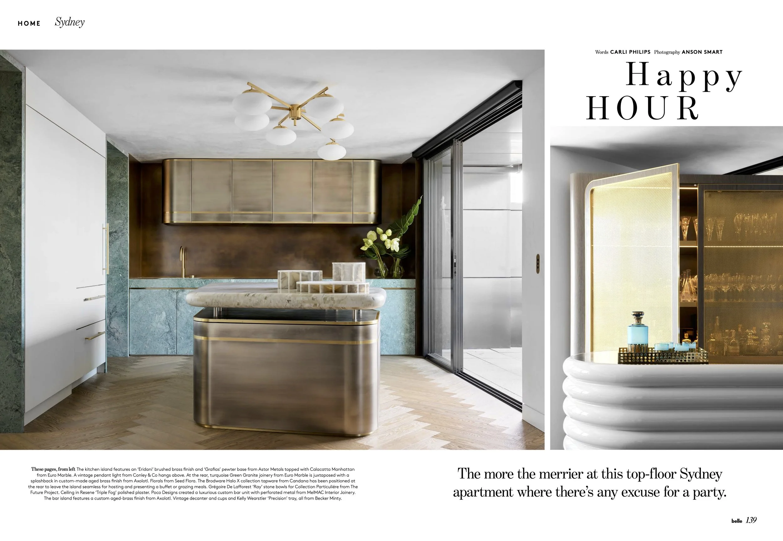 Modern kitchen with wood, brass, and marble accents, featuring a central island, cabinetry, and glass sliding doors.