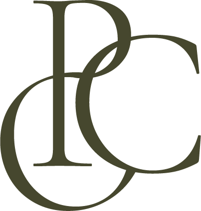 Stylized monogram of the letters D, P, and C overlapping in muted green color.