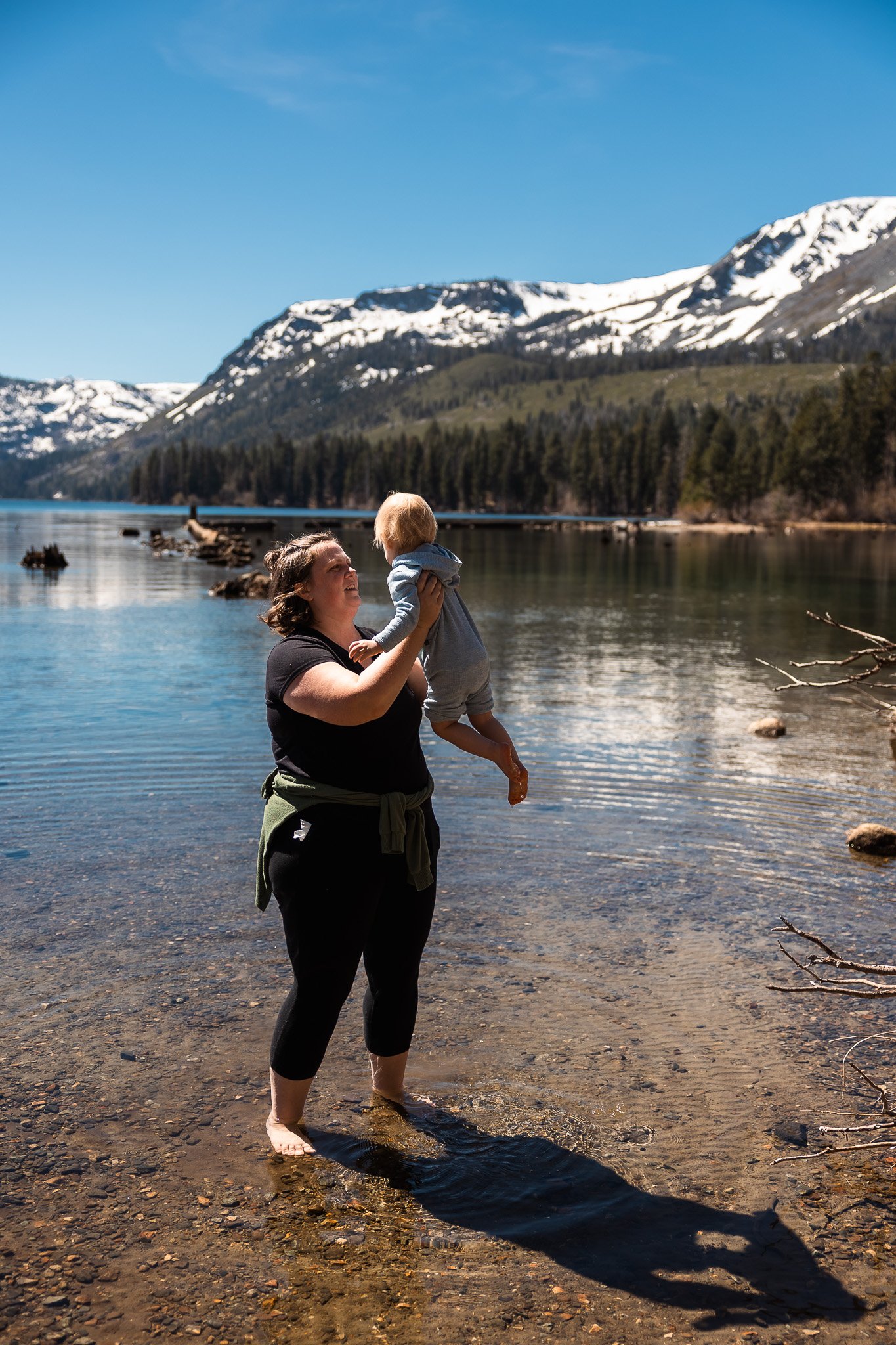 Mom Lifting Toddler at Fallen Leaf Lake Shoreline