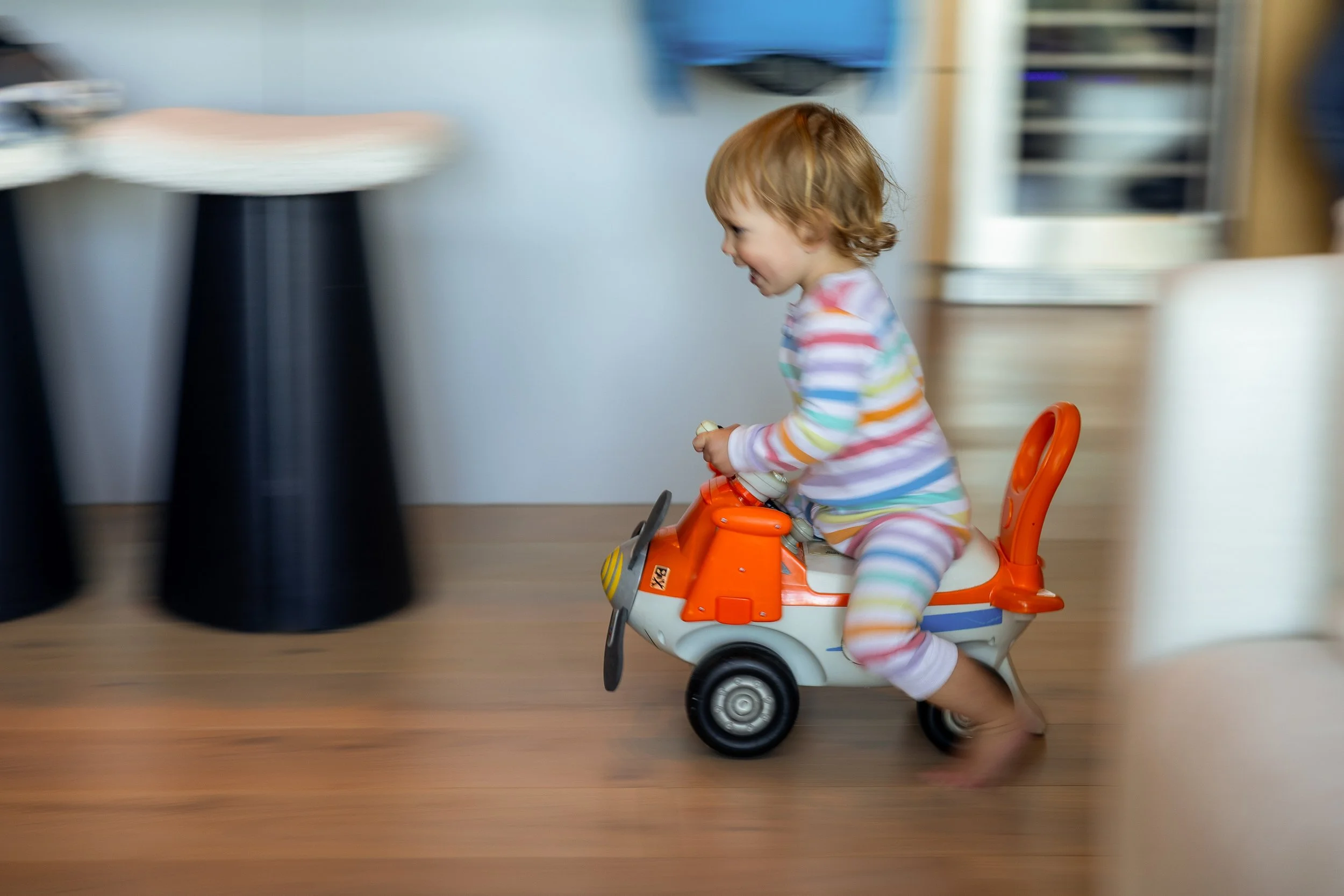 Sara's youngest tears around the Tahoe cabin on his favorite ride-on toy, completely in his element on the family's getaway. Documentary family portrait by Ruwan & Diana Photography.