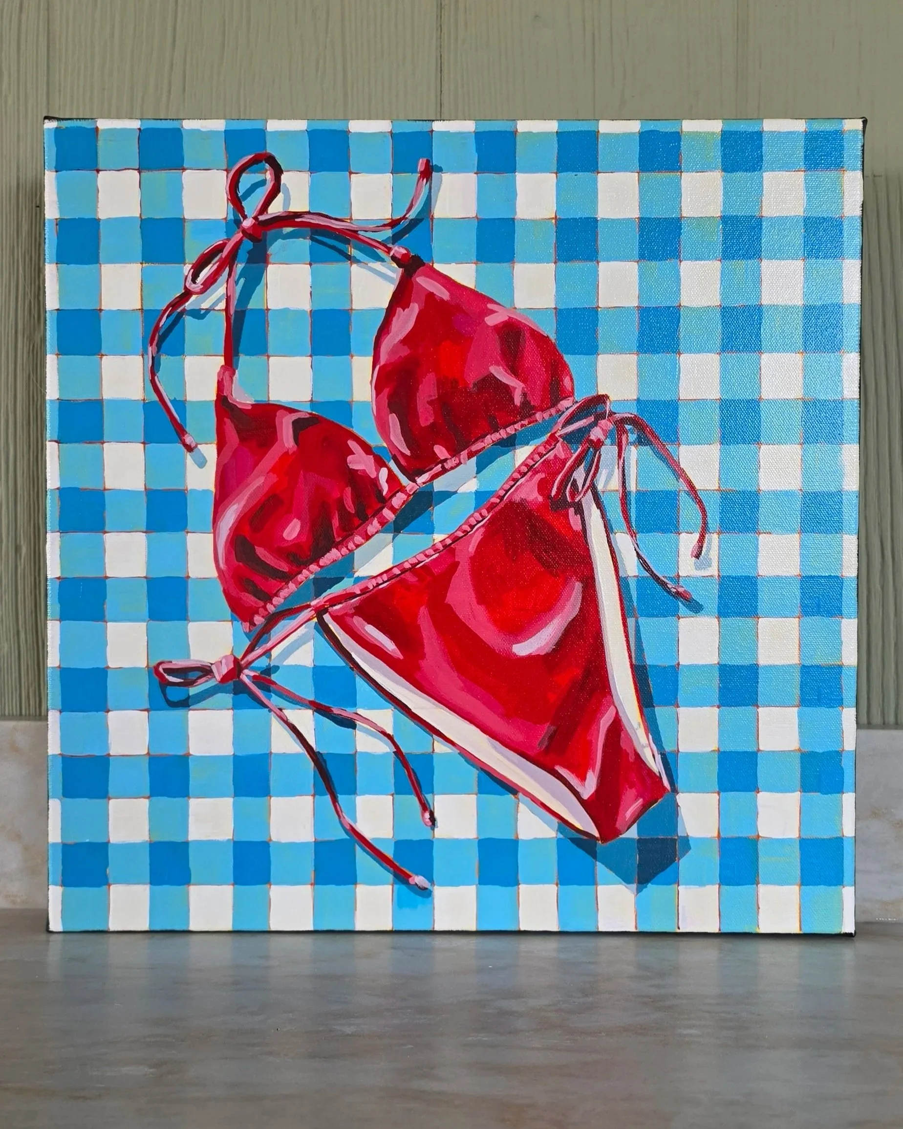 Original 16×16 acrylic painting of a bright red bikini on a blue and white gingham background by artist Robin Rae Werner