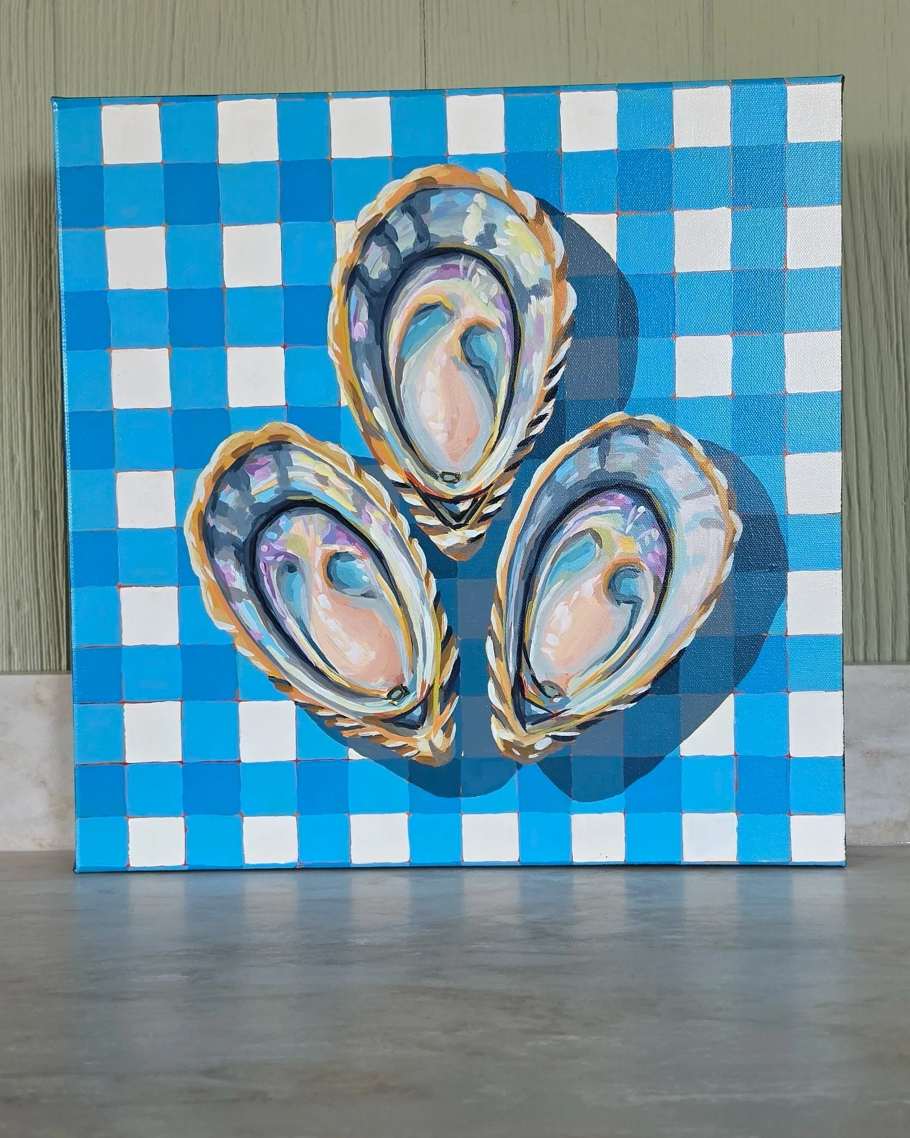 Original 16×16 acrylic painting of three colorful oysters on a blue and white gingham background by artist Robin Rae Werner