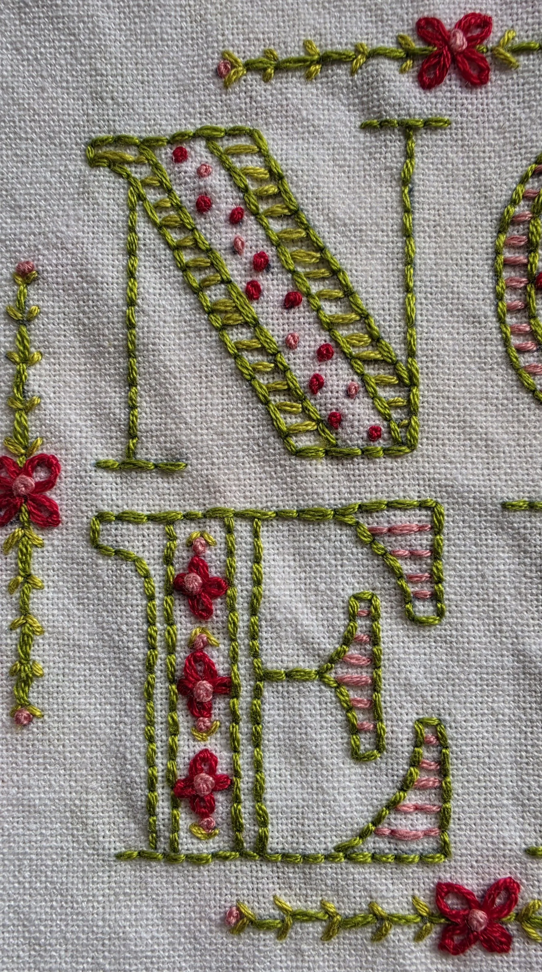 Floral embroidery detail on handmade Noel dish towel