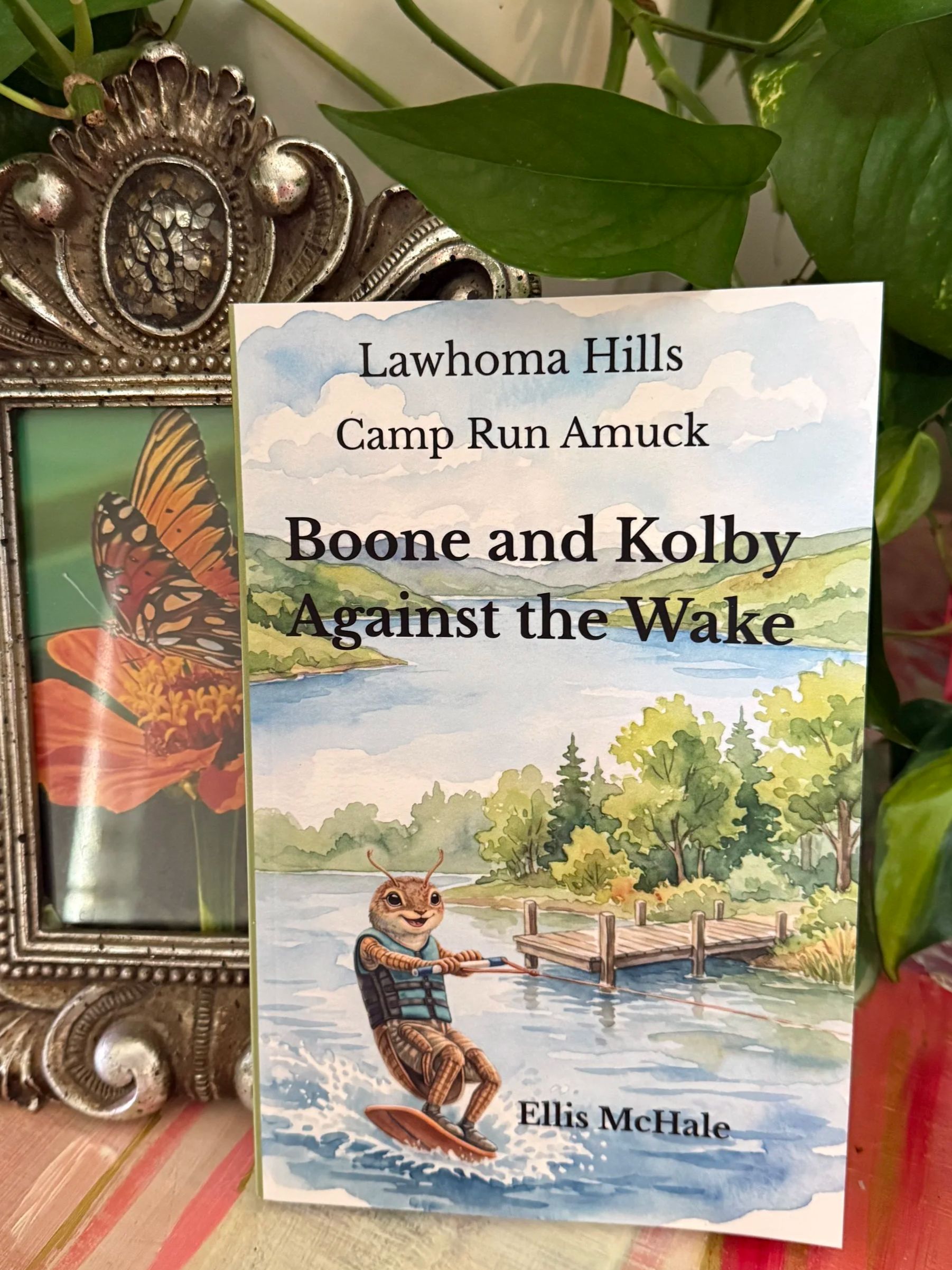 A book title is 'Boone and Kolby Against the Wake' by Ellis McHale. Featuring a beetle on a wakeboard in summertime.