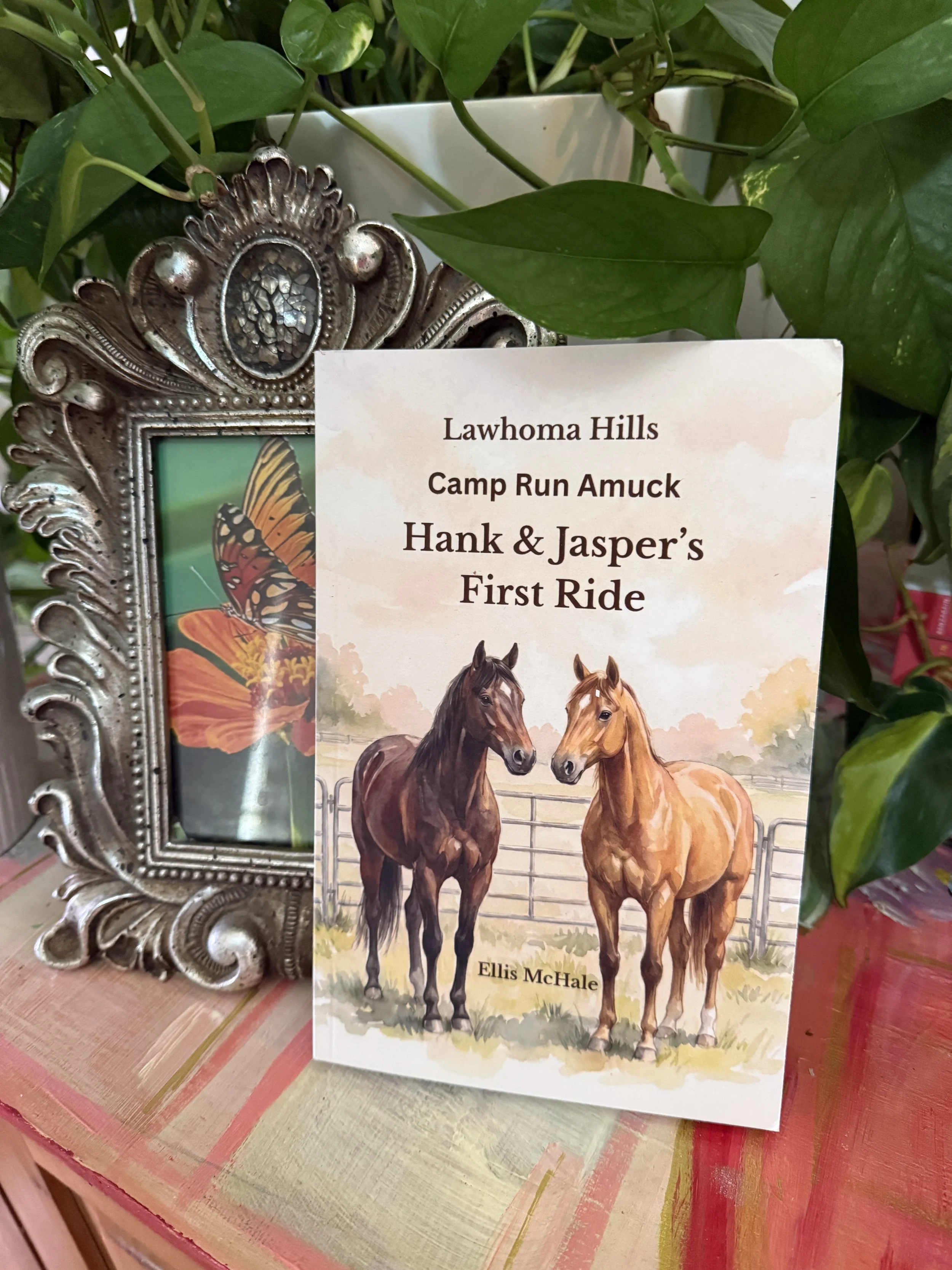 A book titled "Camp Run Amuck" Hank & Jasper's First Ride by Ellis McHale features an illustration of two horses, one dark brown and one light brown, standing in a pasture with a wooden fence in the background.