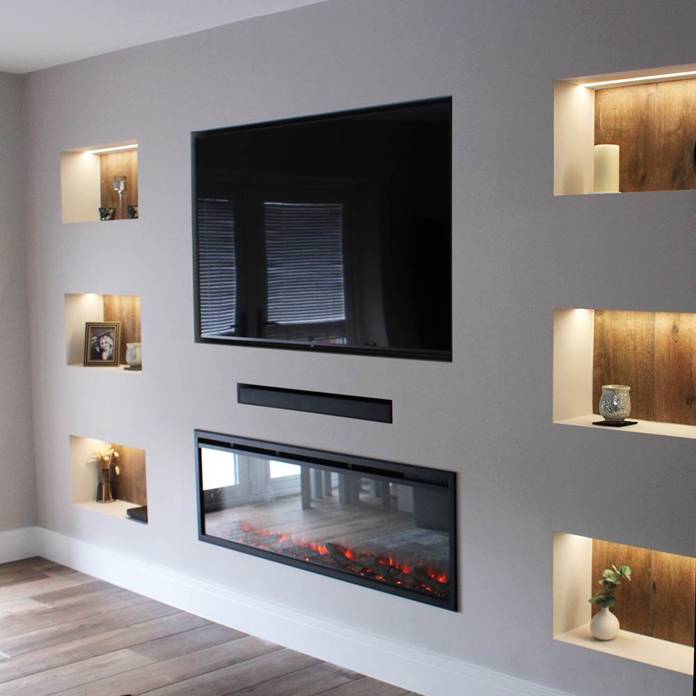 Contemporary media wall with clean lines, recessed shelving alcove units and integrated LED lighting with recessed fireplace and discreet soundbar storage
