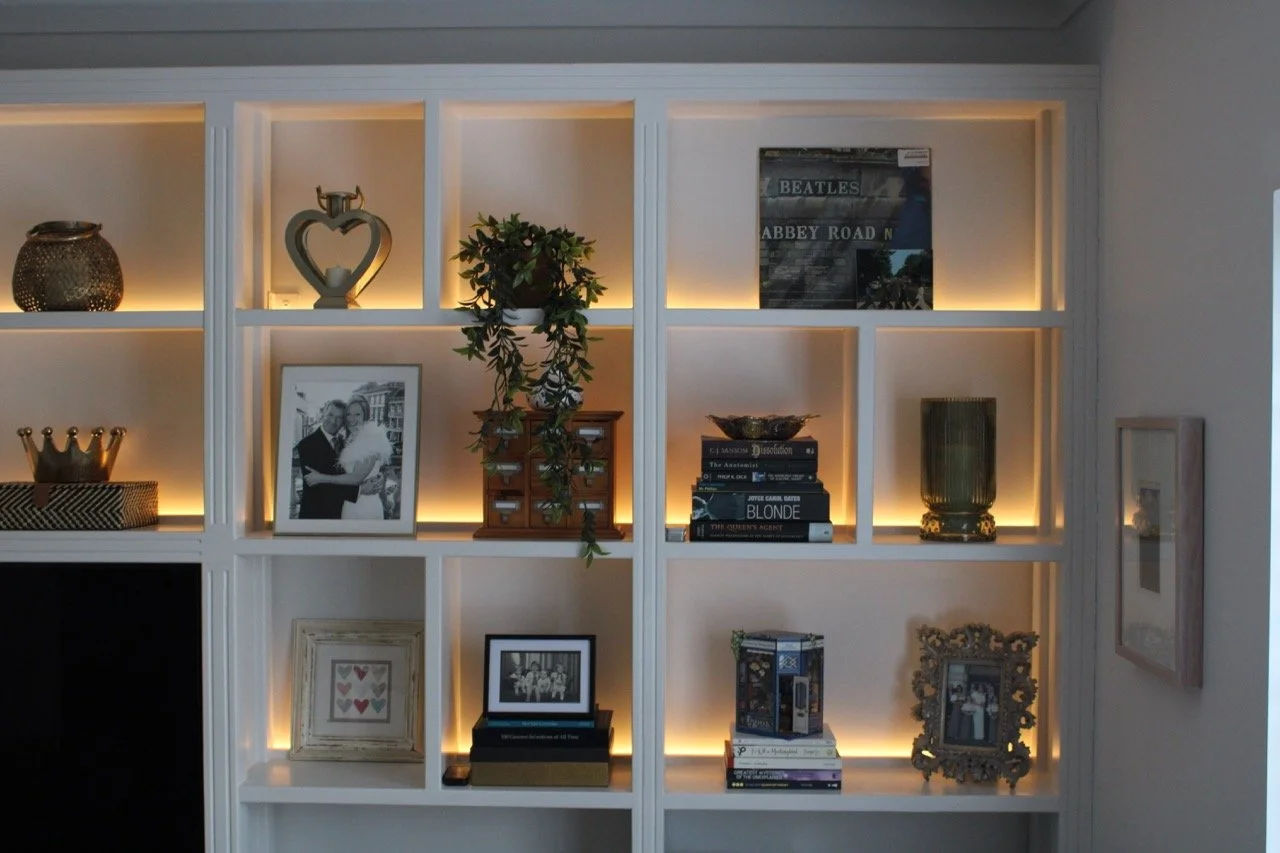 Close-up of bespoke, shaker-style fitted shelving with hand-painted MDF finish, styled with decorative items.