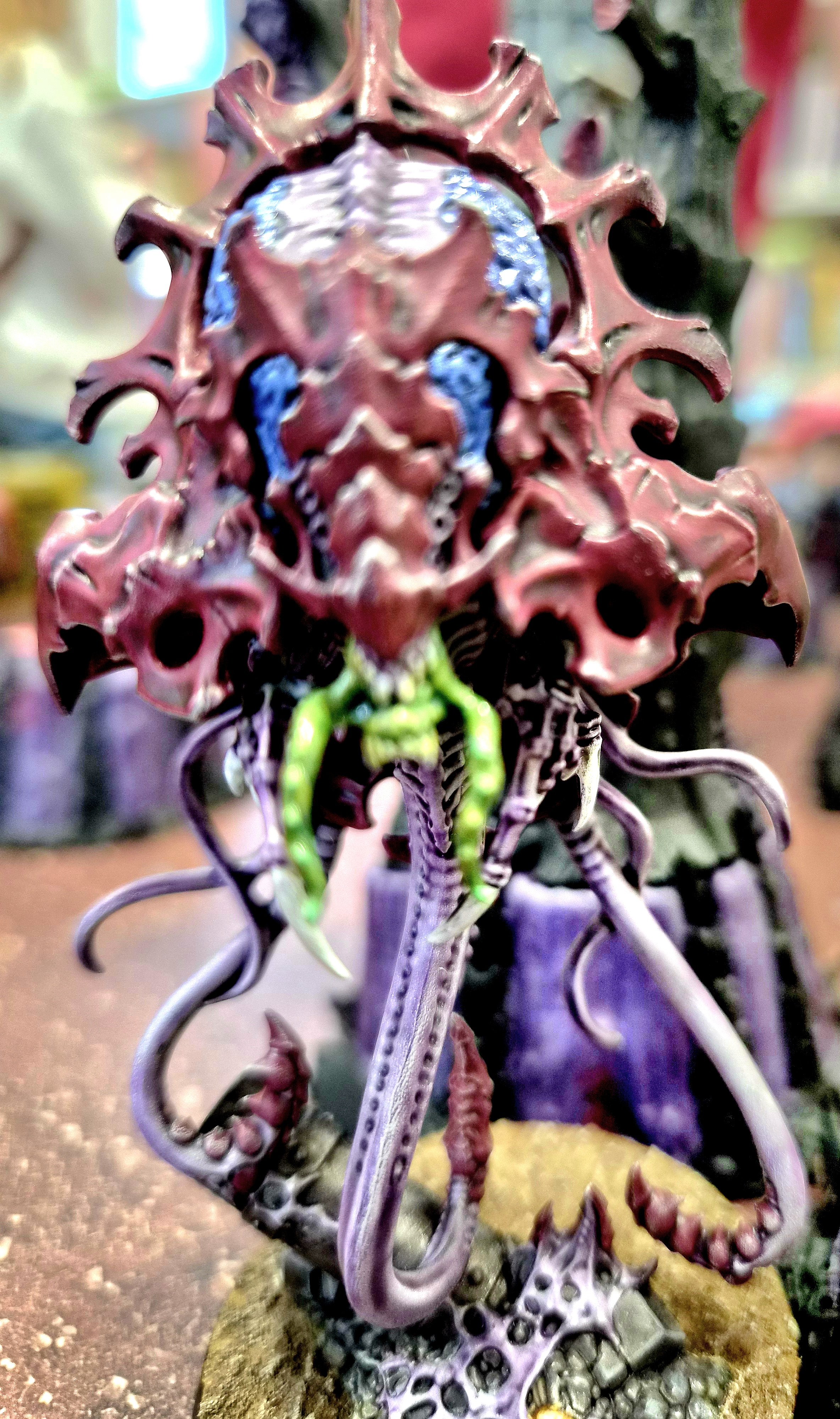 Tiranid with a large, spiky head, multiple tentacle-like appendages, and a mix of organic, alien, and plant-like features.