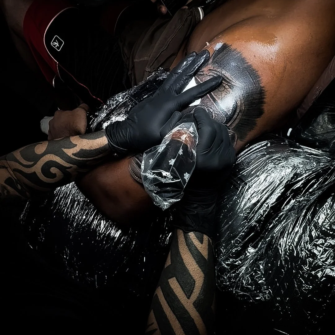 Tattoo artist working on custom tattoo at InkArt Tattoo Studio Miami