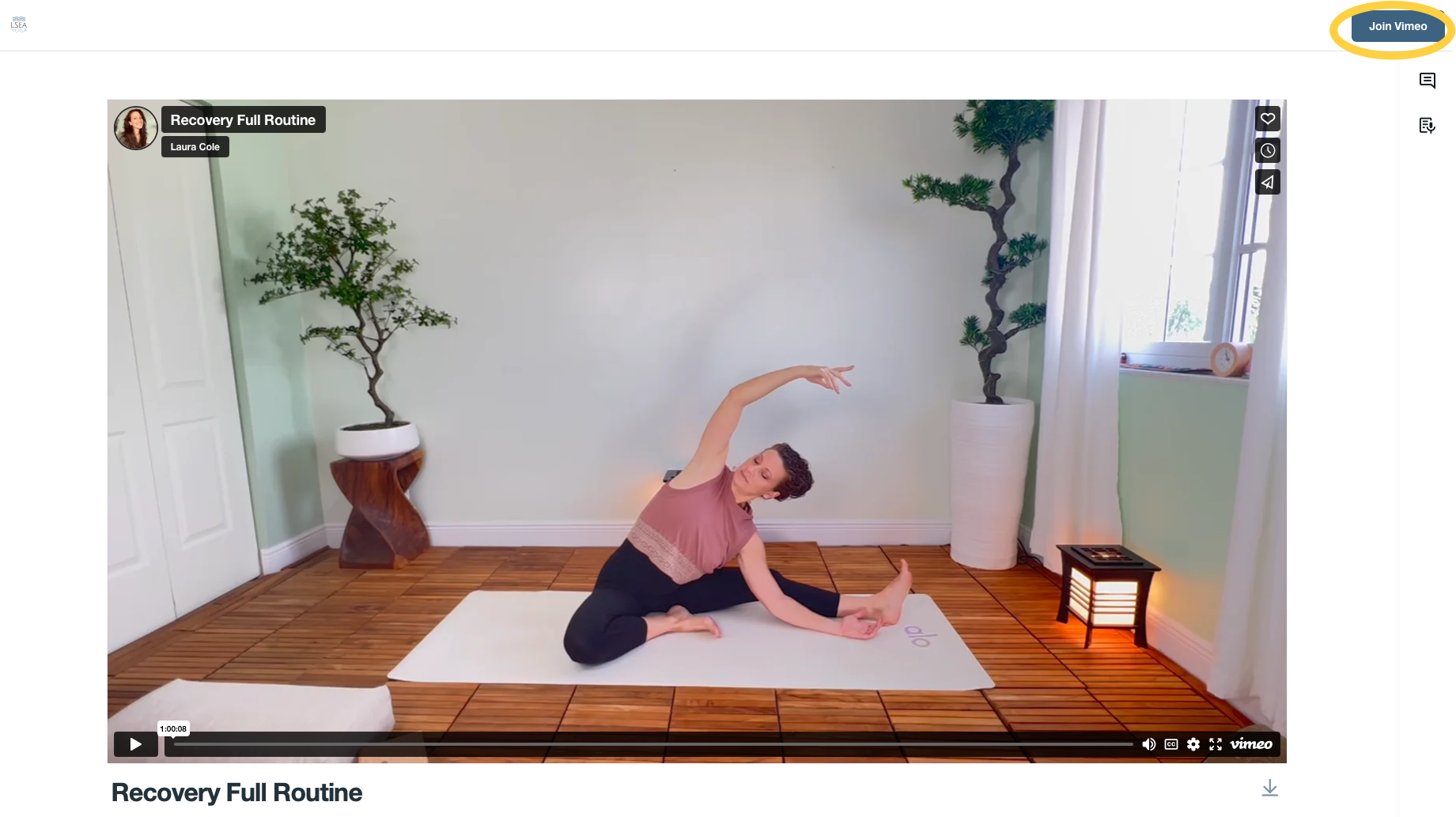 Woman in pink top and black pants practicing yoga in a bright room with wooden flooring, large potted trees, white curtains, and a small lamp, performing a seated side stretch pose.