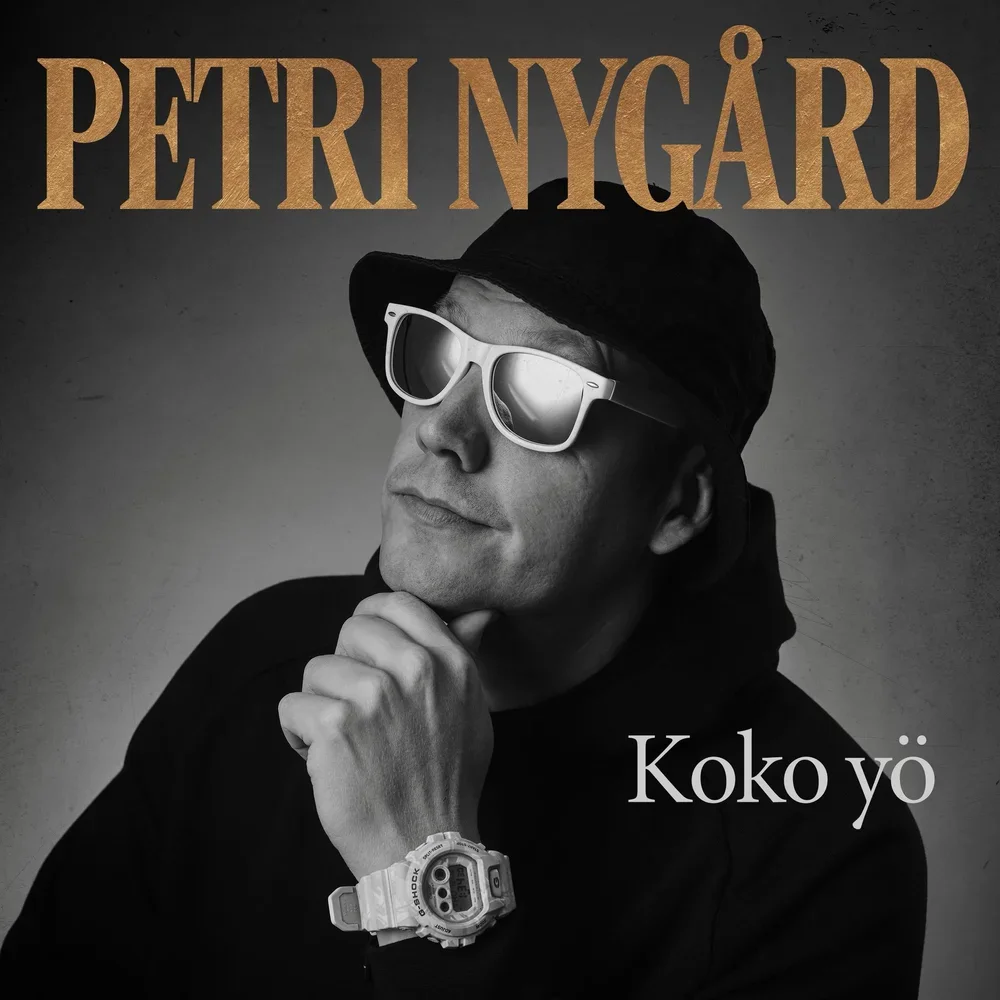 Black and white album cover featuring a man wearing sunglasses, a black cap, and a watch, with his hand on his chin. The text on the cover reads 'PETRI NYGÅRD' at the top and 'Koko yö' at the bottom right.