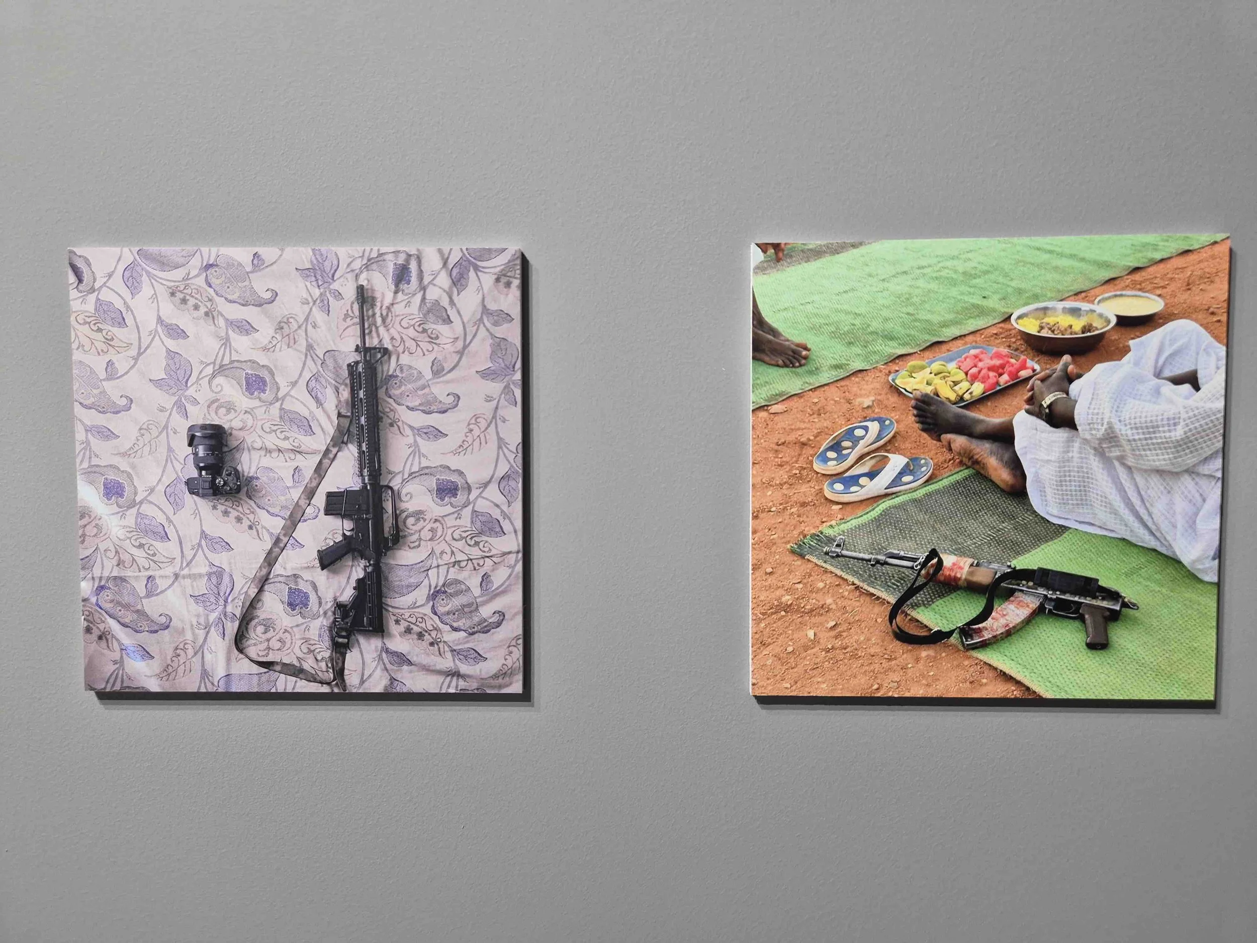 Side-by-side display of two photographs: the first photo shows a firearm and a camera on a floral fabric background; the second photo depicts a person in white clothing sitting on a green mat outdoors, with a toy gun, sandals, and bowls of food nearb