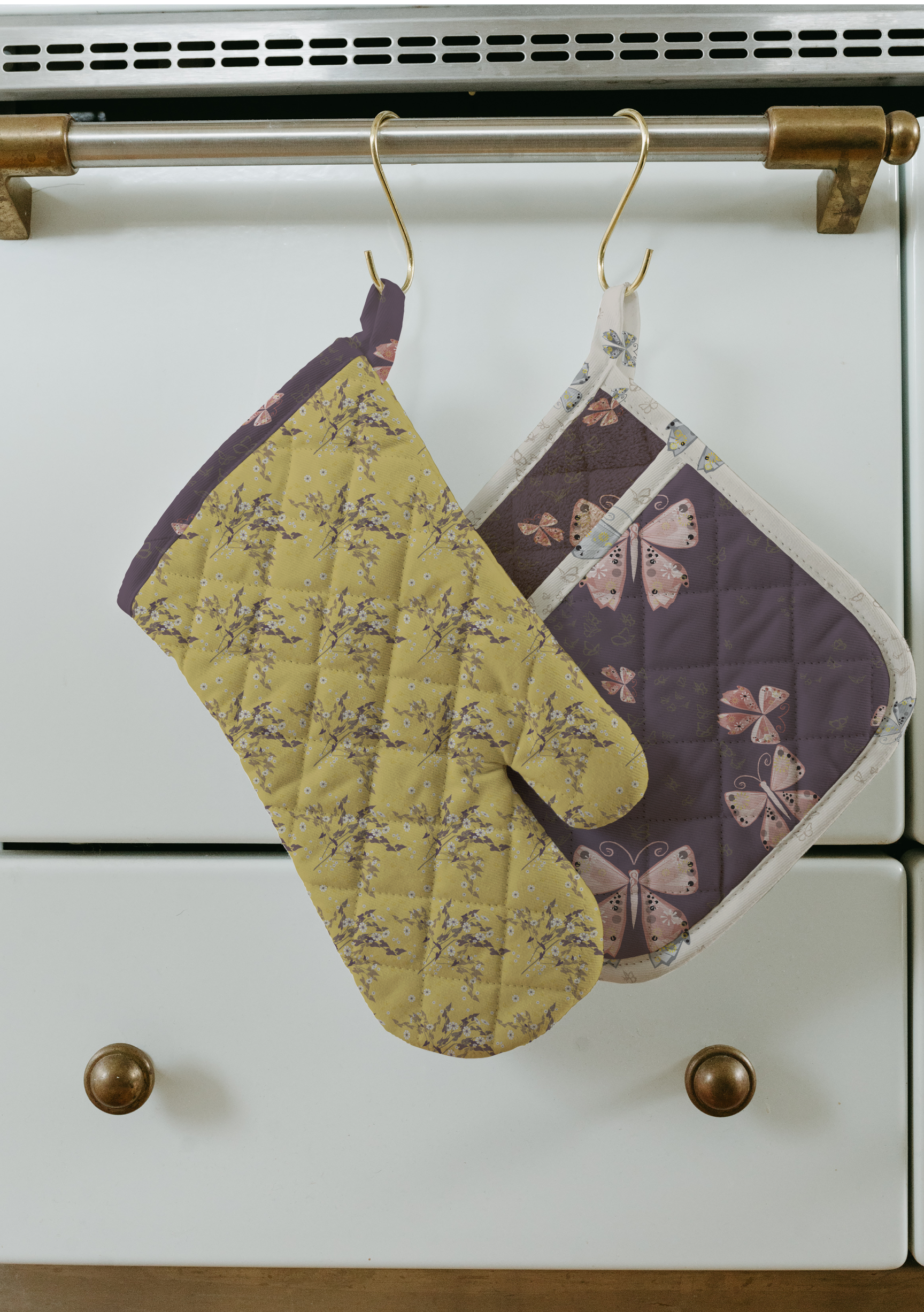 Butterfly-pattern oven mitts featuring an original hand-drawn surface pattern by Driftzen Studio, shown as a kitchen textile mockup.