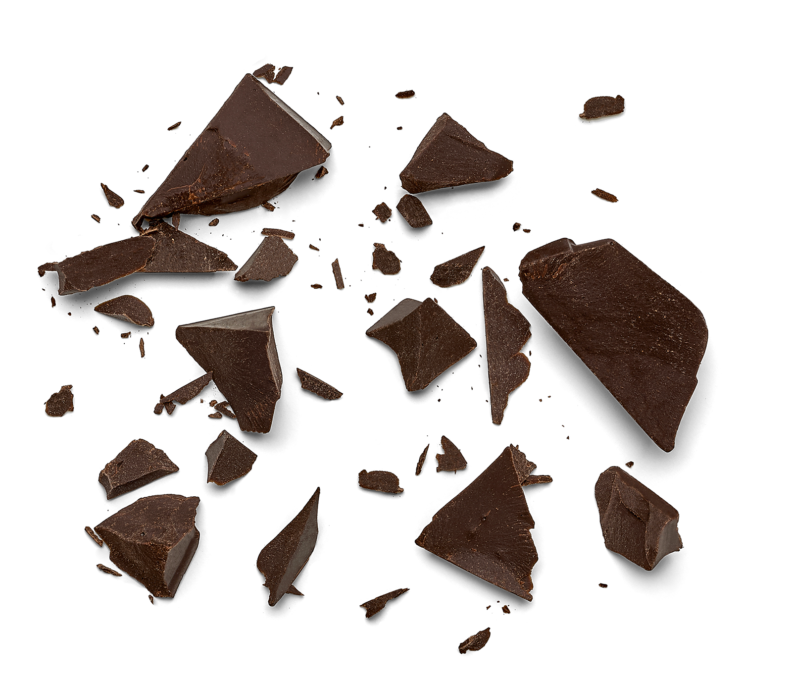 Broken pieces of dark chocolate scattered on a white background.