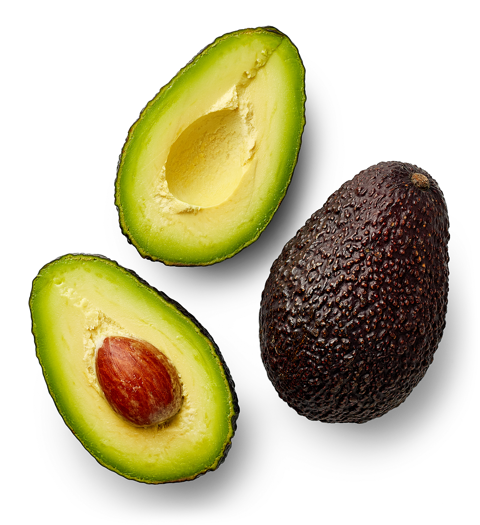 A whole ripe avocado with dark, bumpy skin, and a halved avocado showing green flesh and a large seed inside.