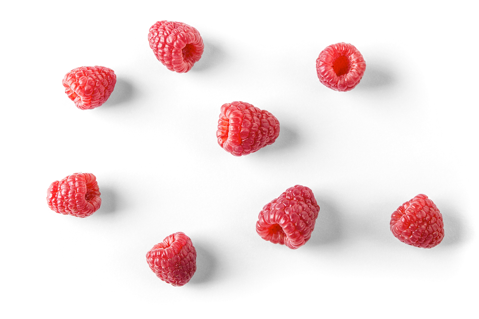 Multiple fresh raspberries scattered on a black background.