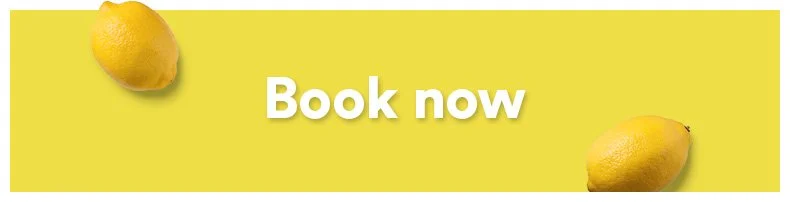 Yellow banner with two lemons, one in the top left corner and one in the bottom right corner, and the text 'Book now' in bold white letters in the center.