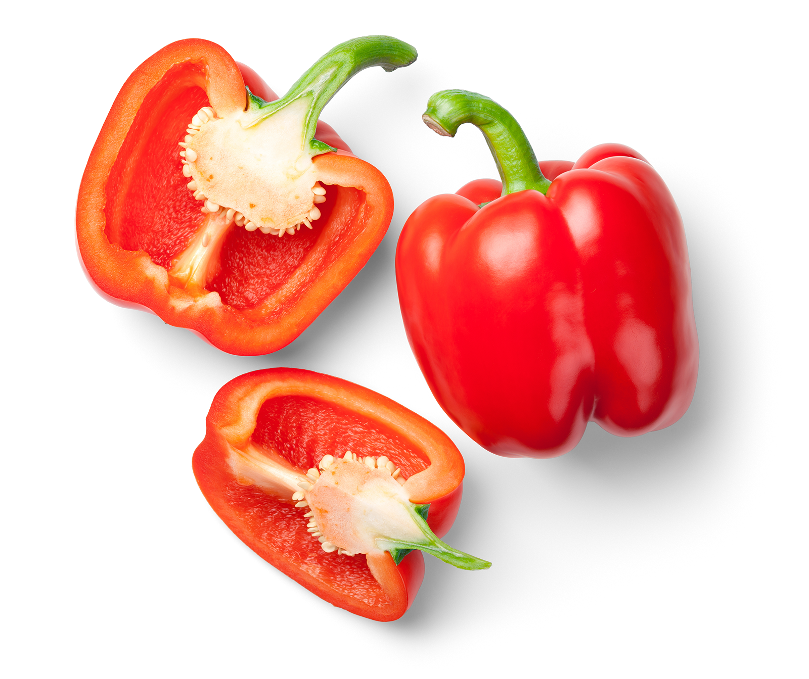 Whole red bell pepper and two halves showing the interior with seeds and white pith.