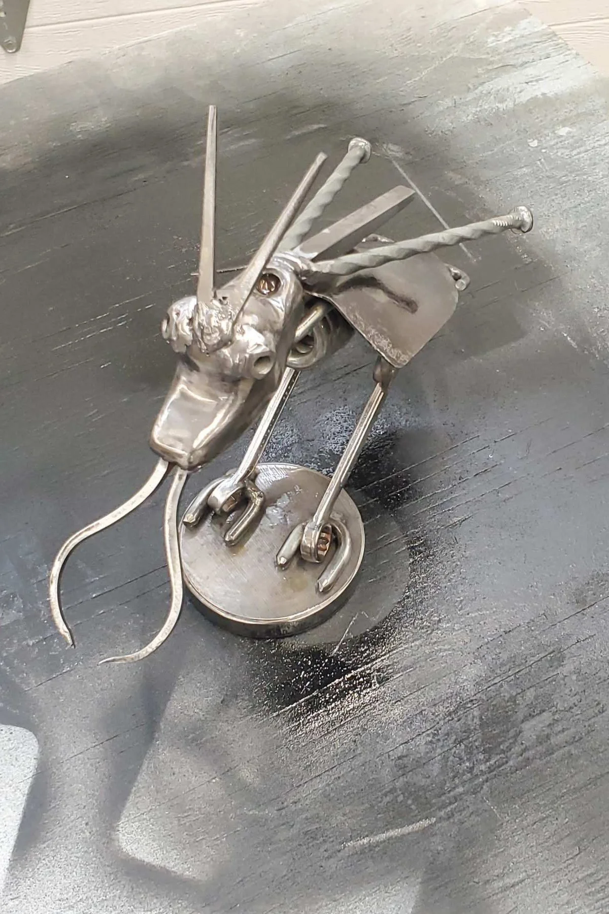 Metal sculpture mounted on a circular base