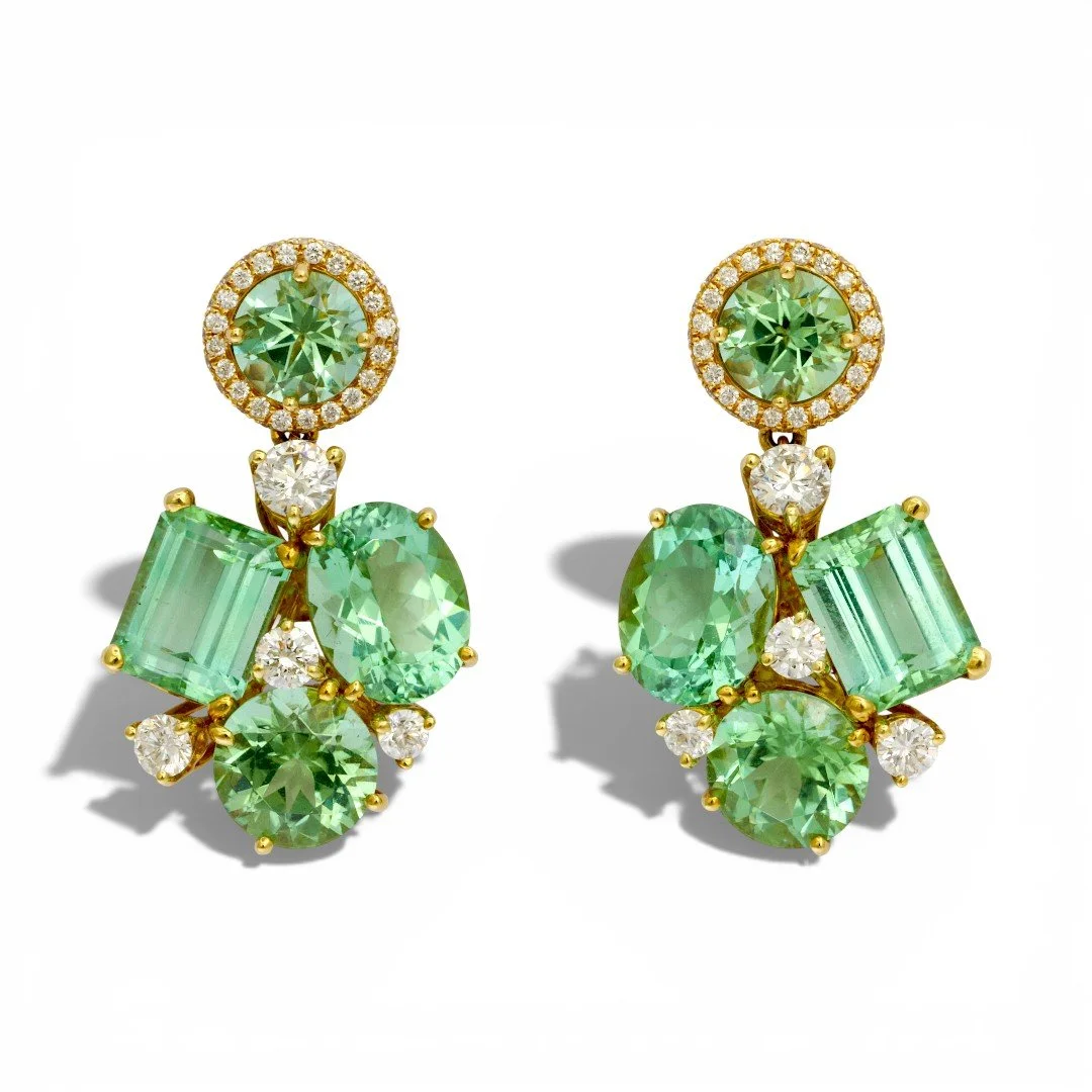 Donna Vock pearl cluster earrings with green and clear gemstones, including round, rectangular, and oval cuts, set against a white background.