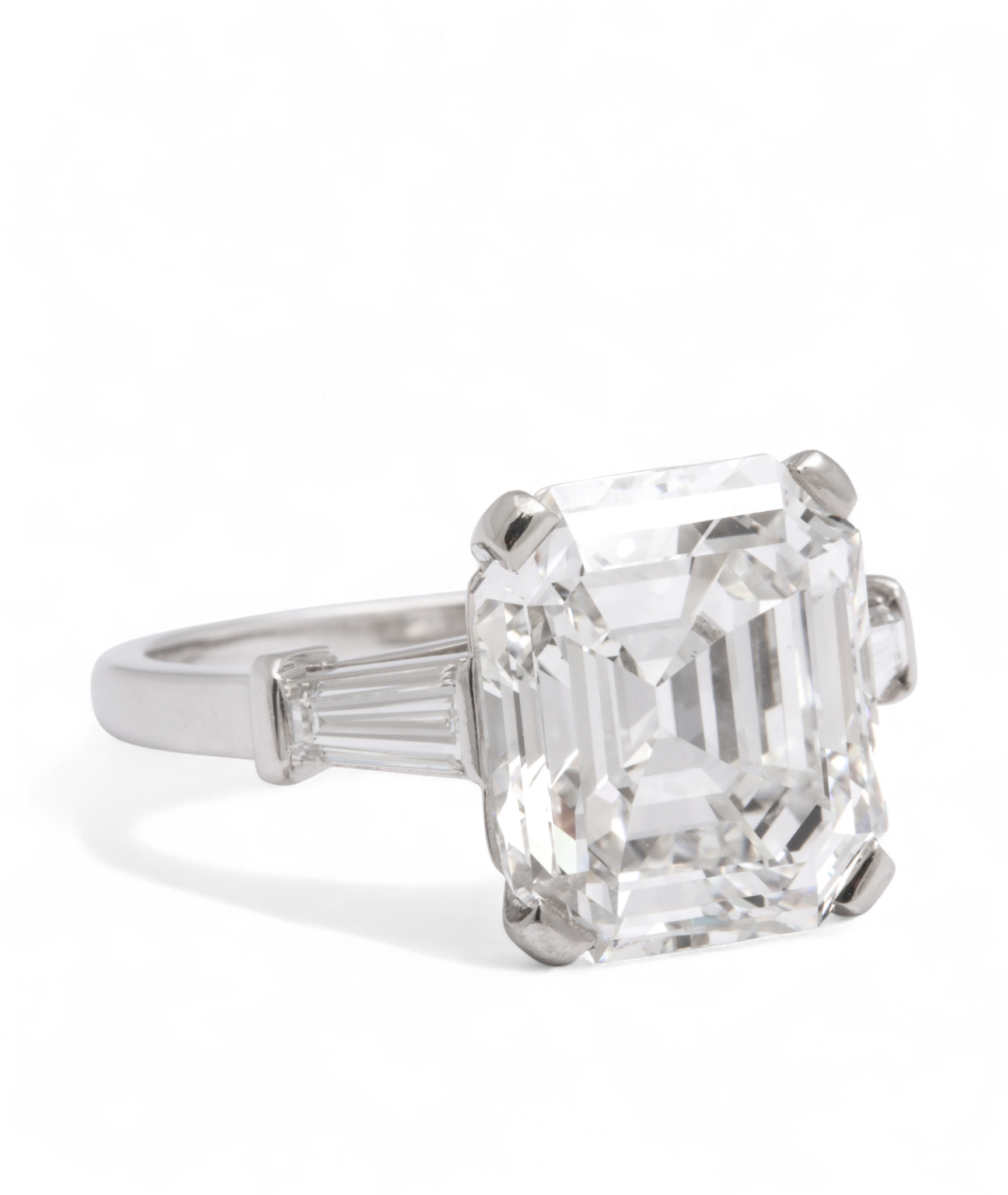 Custom Donna Vock engagement ring. A silver ring with a large rectangular clear gemstone, likely a diamond, set in a four-prong setting, against a white background.