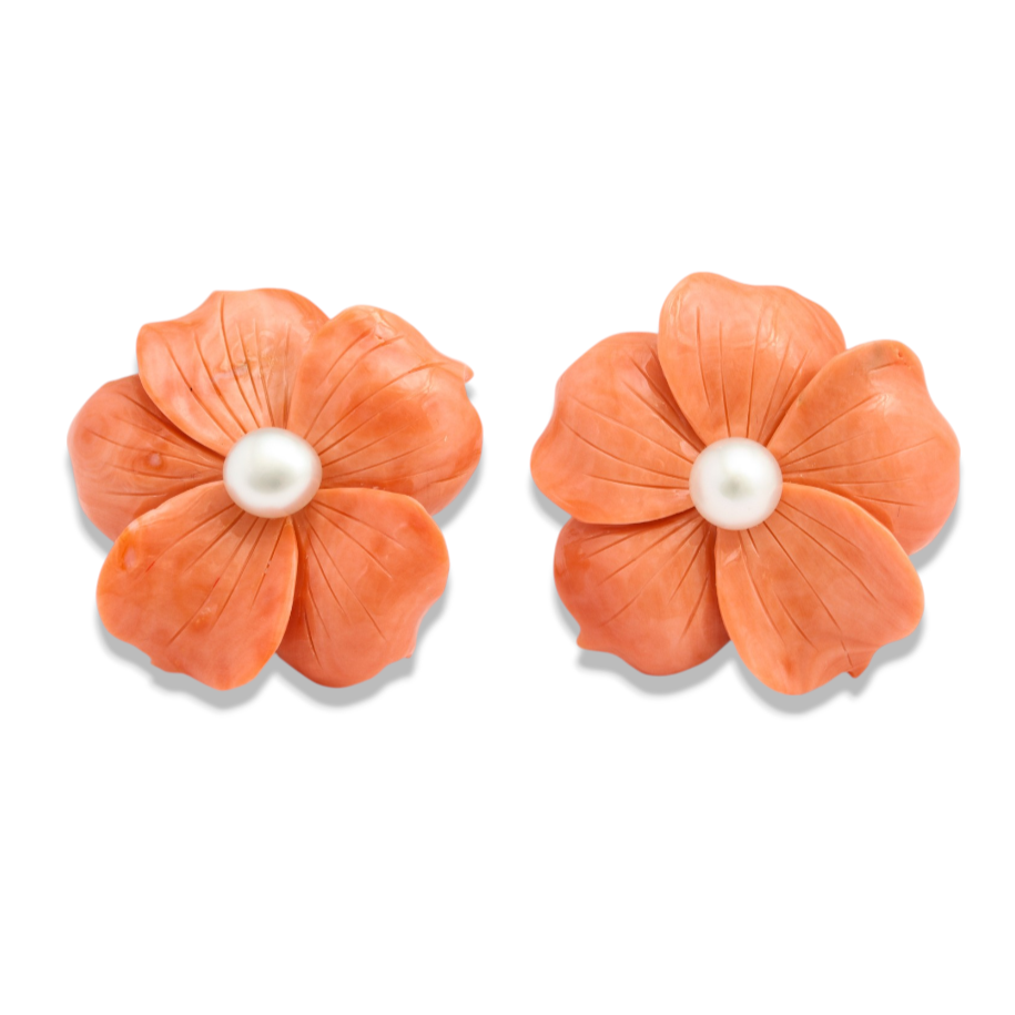Custom Donna Vock. Two orange flower-shaped coral earrings with pearls in the center, placed on a white background.