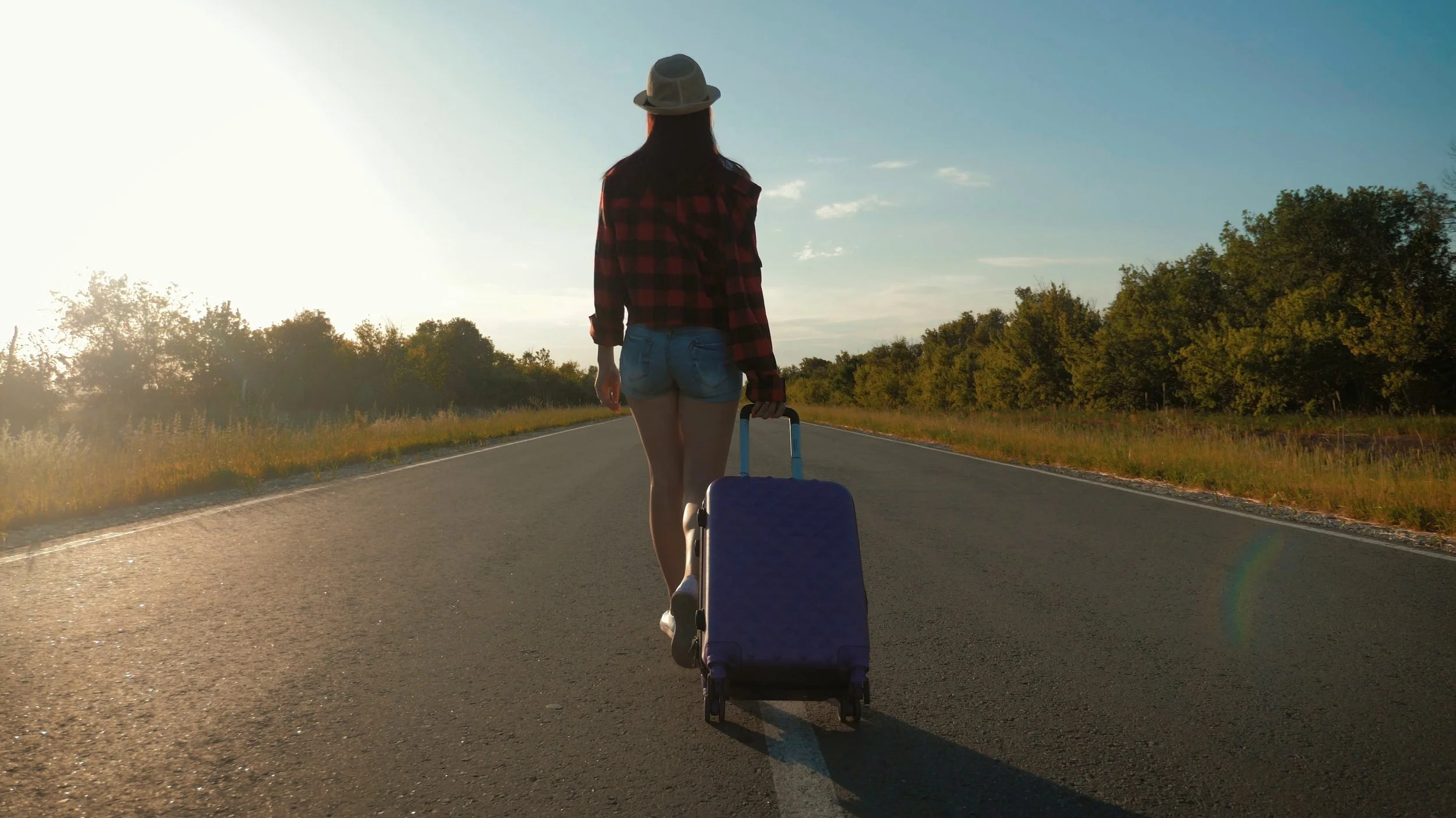 young-woman-with-a-suitcase-on-road-funny-beautiful-girl-traveler-travel-concept-video-SBI-350081013.jpeg