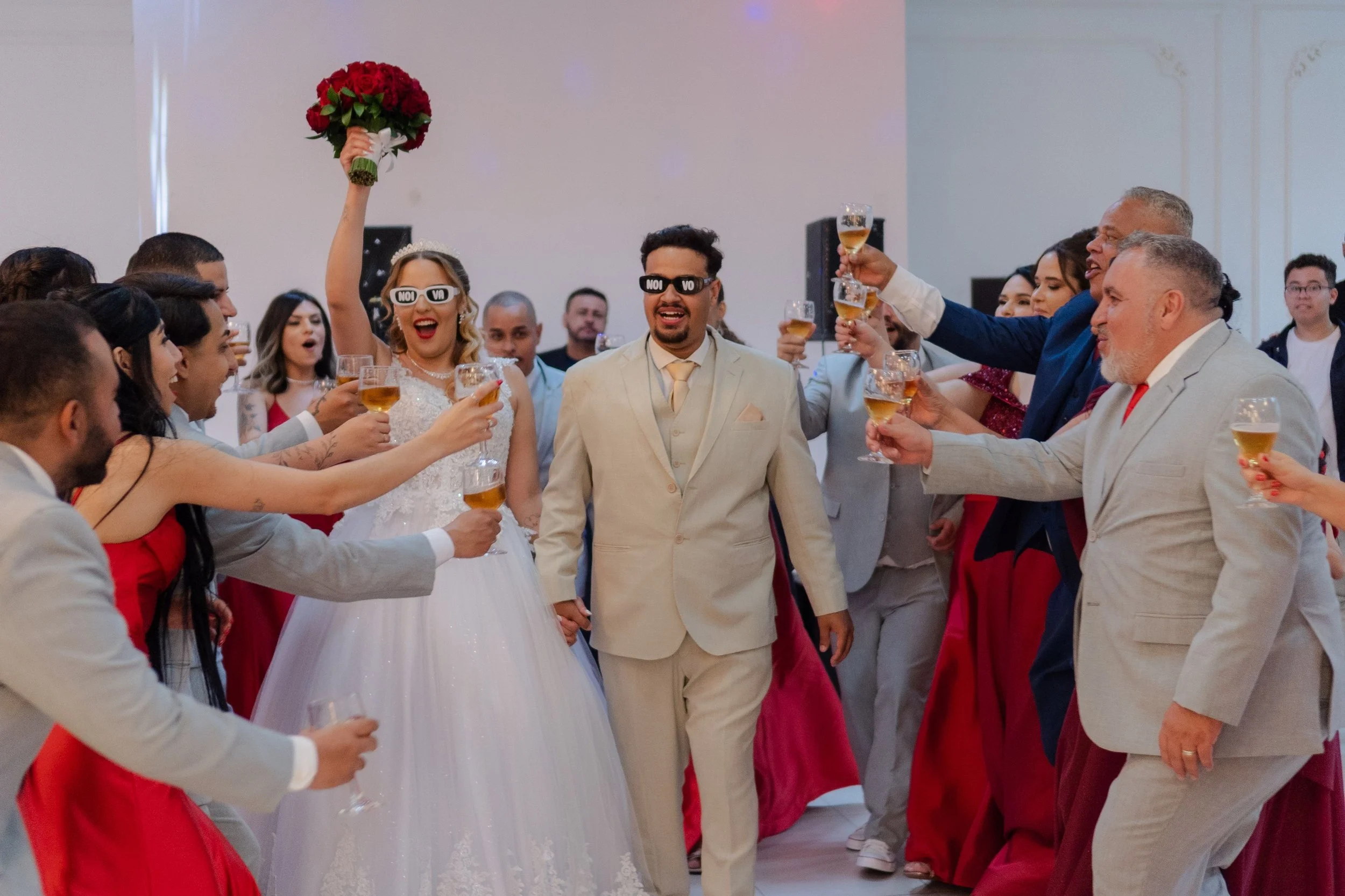 Bride and groom celebrating with wedding guests raising glasses in a toast
