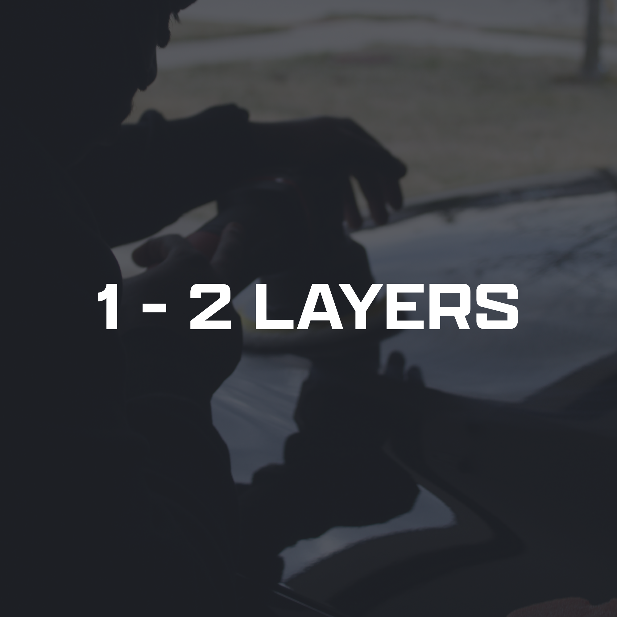 Close-up of a person's silhouette with their hand resting on a car dashboard, with text overlay stating '1-2 Layers'.