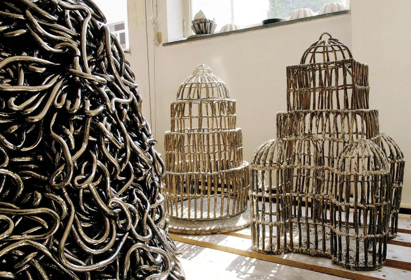 Cages, 2004, ceramic, glaze, bird droppings (image Griet Dekoninck)