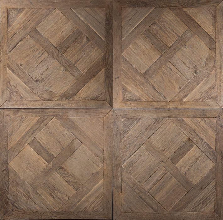 Cuatro baldosas de madera con patrón en diamante.
