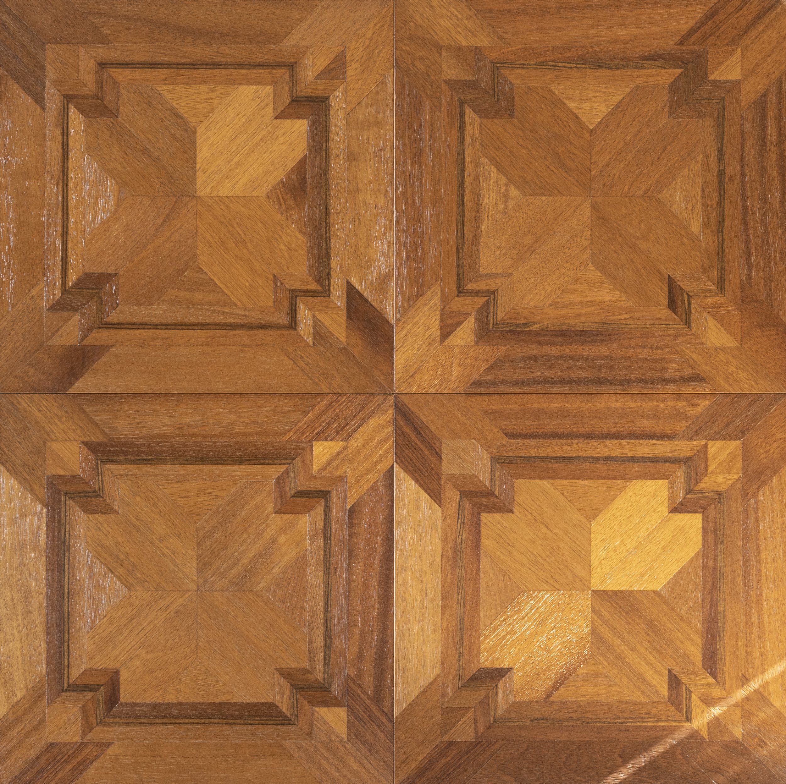 Cuatro paneles de madera con un diseño geométrico en relieve, formando patrones en forma de estrellas y cuadros.
