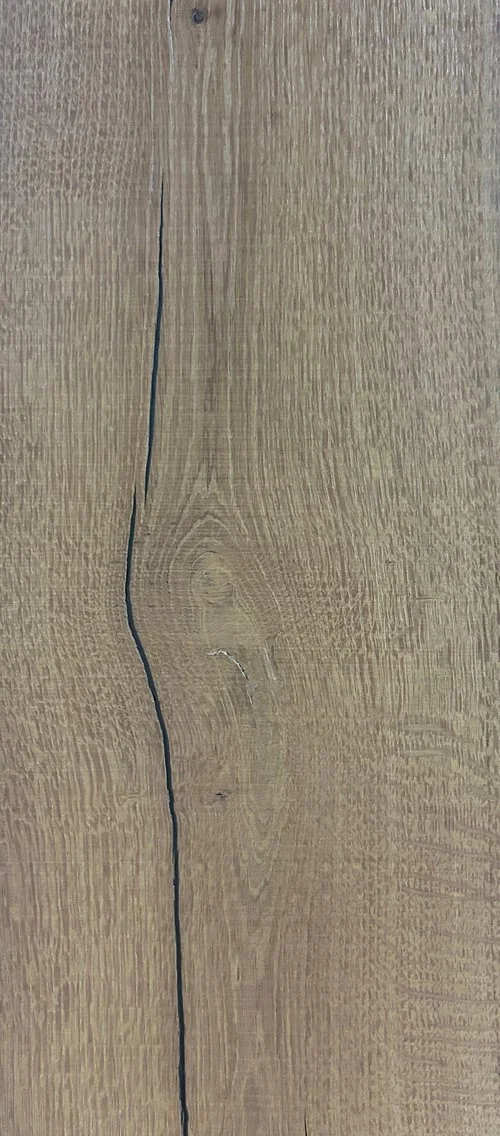 Superficie de madera con una grieta larga y curvada en el centro.