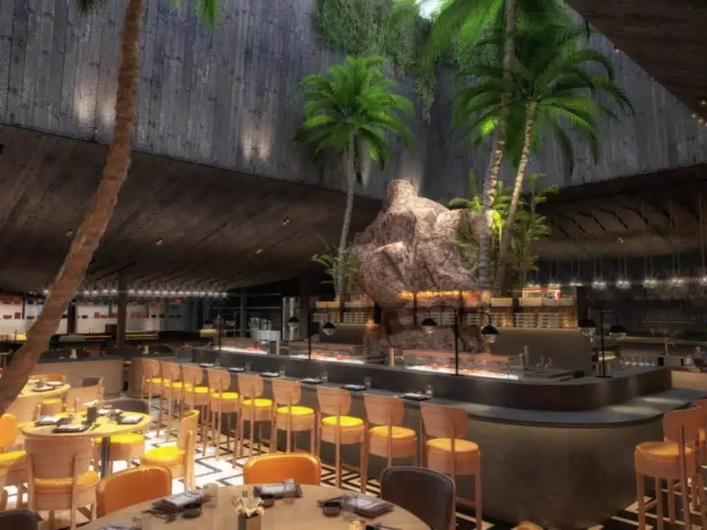 Jarrón de cerámica con unas ramas secas en un fondo claro, en una superficie de madera.