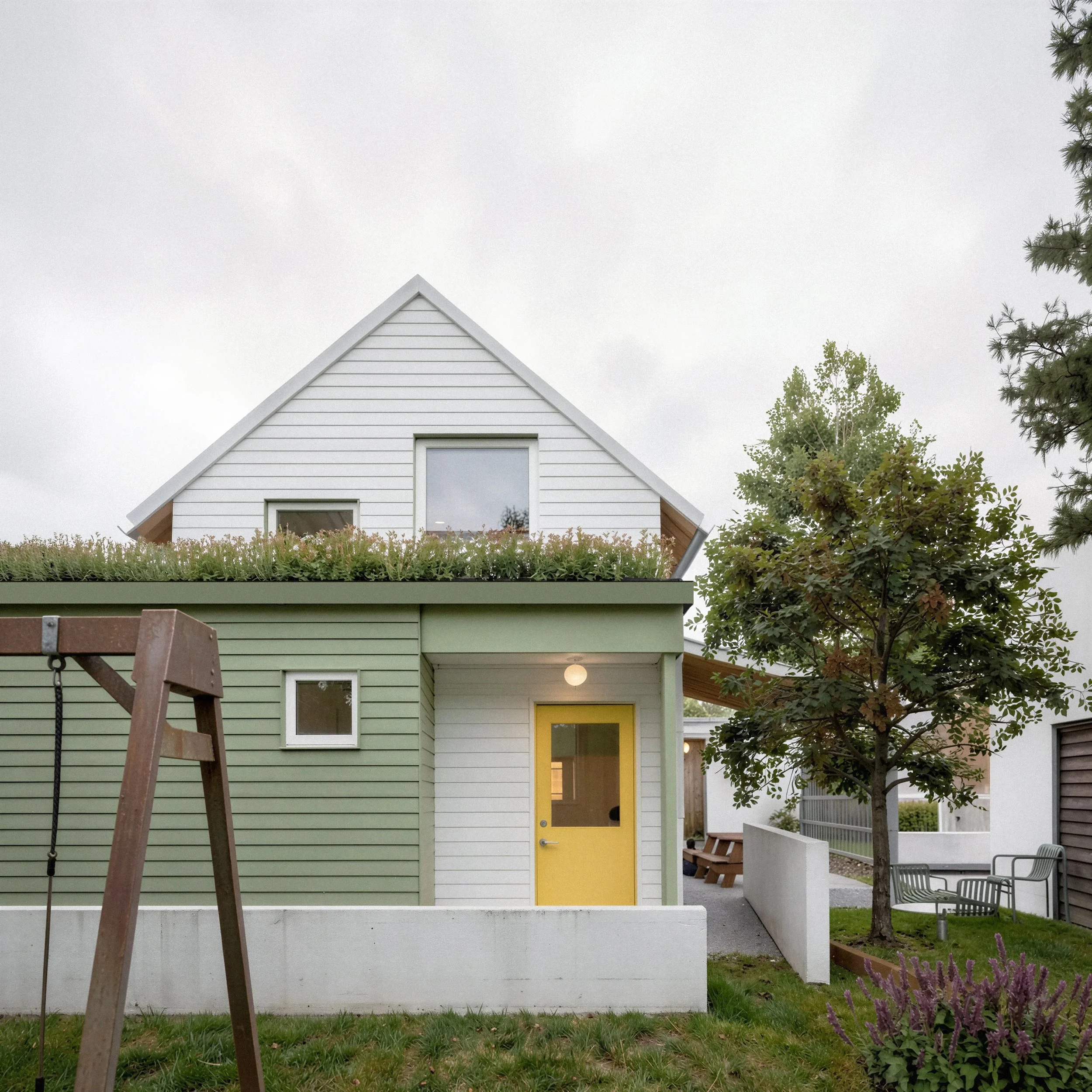 An image of a contemporary ADU with a sustainable green roof and subtle sage green color palette. colorful.