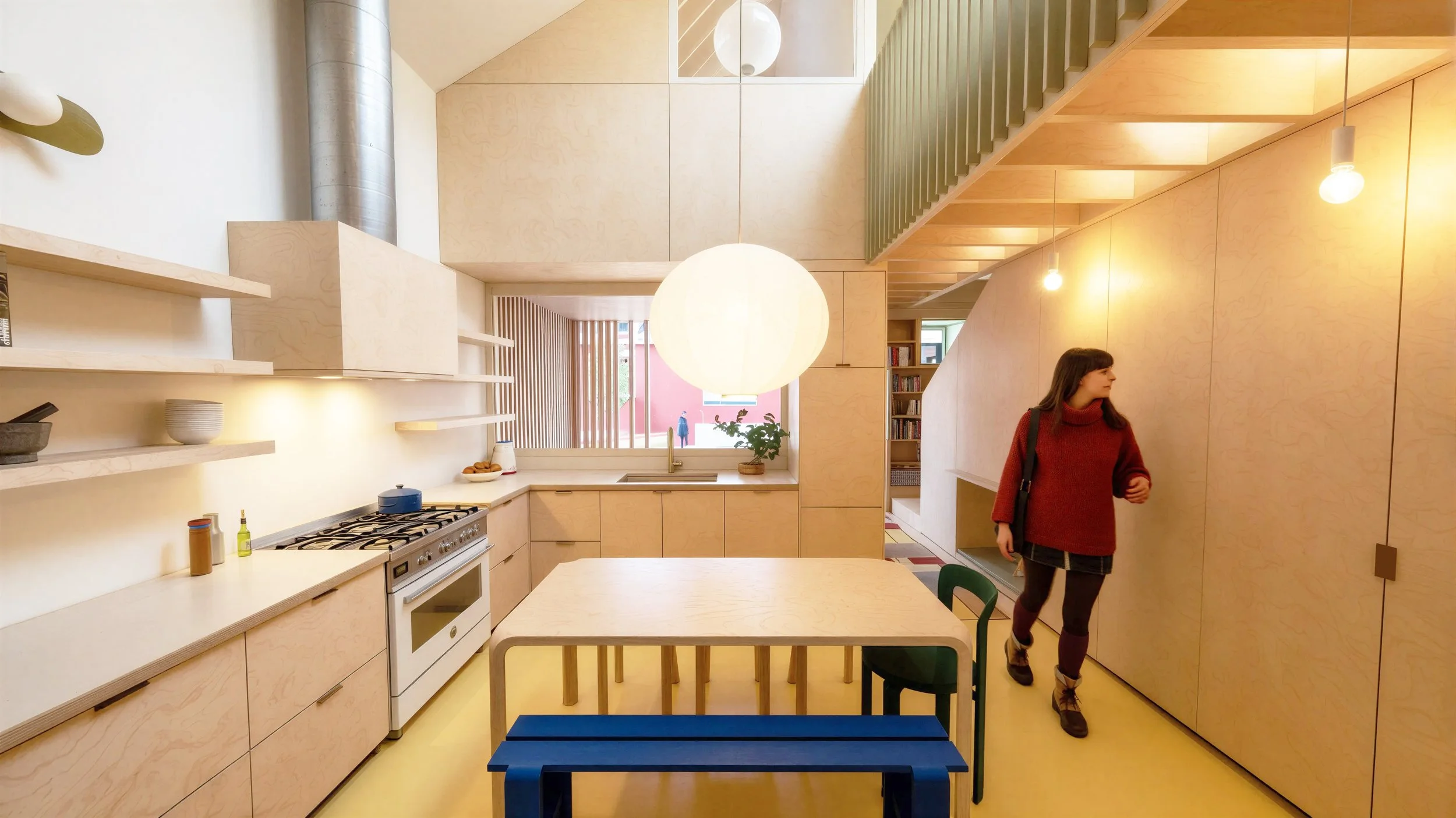 An image of the kitchen of a contemporary scandivanian rowhouse with baltic birch plywood, and soft sage green colors. Artek Furniture. HAY furniture. Nashville Designer.