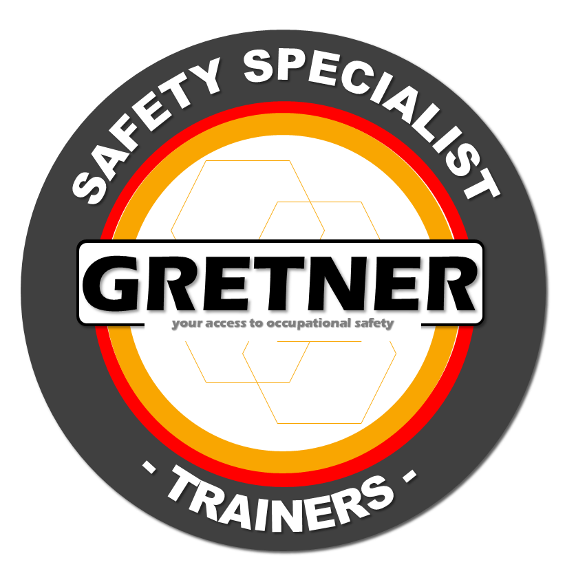 Logo de un programa de capacitación en seguridad laboral llamado GRETNERR, que ofrece entrenamiento especializado en seguridad ocupacional, con un diseño circular que incluye bordes en colores negro, rojo y amarillo, y el texto 'Safety Specialist Trainers'.