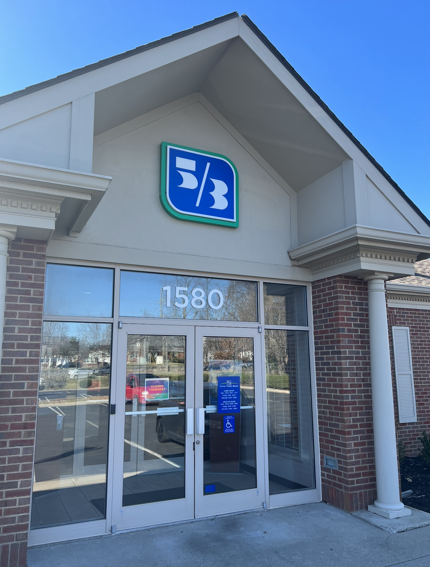 Fifth Third Bank branch located at 1580 with a logo on the building and a glass door.