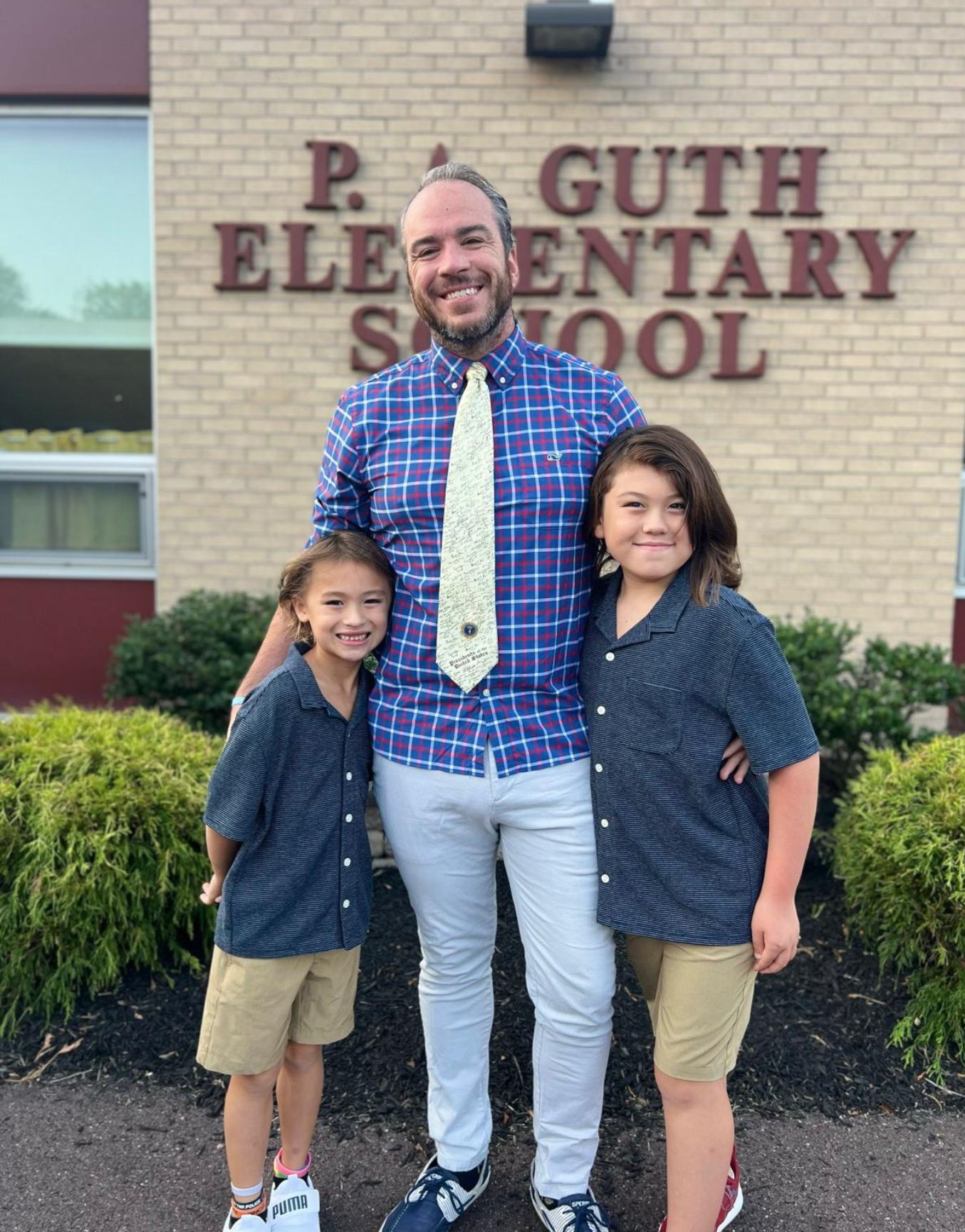 Bradley Merkl-Gump and his two children standing outside of Guth Elementary School in Pennridge School District.