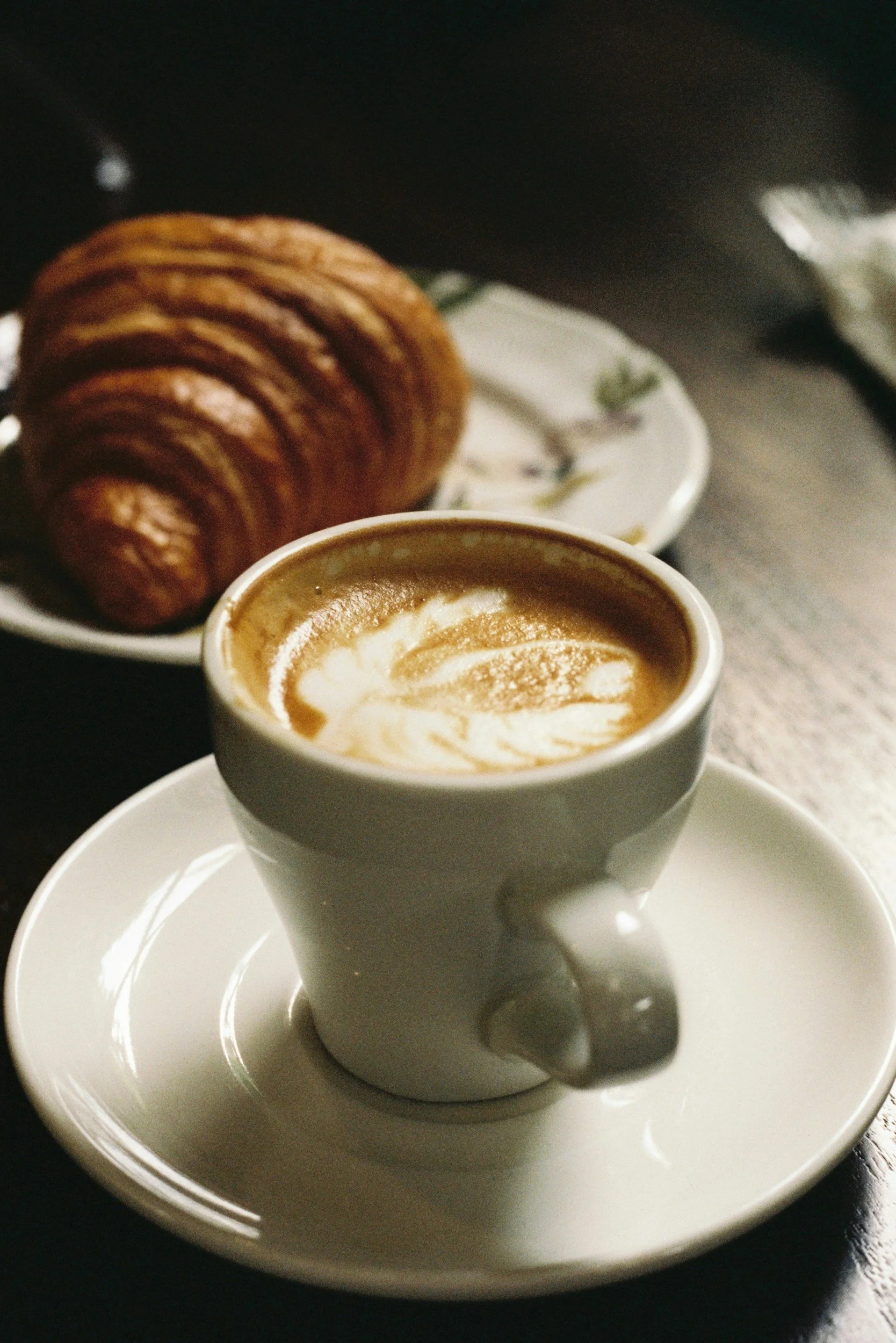 Cortado and croissant in cafe