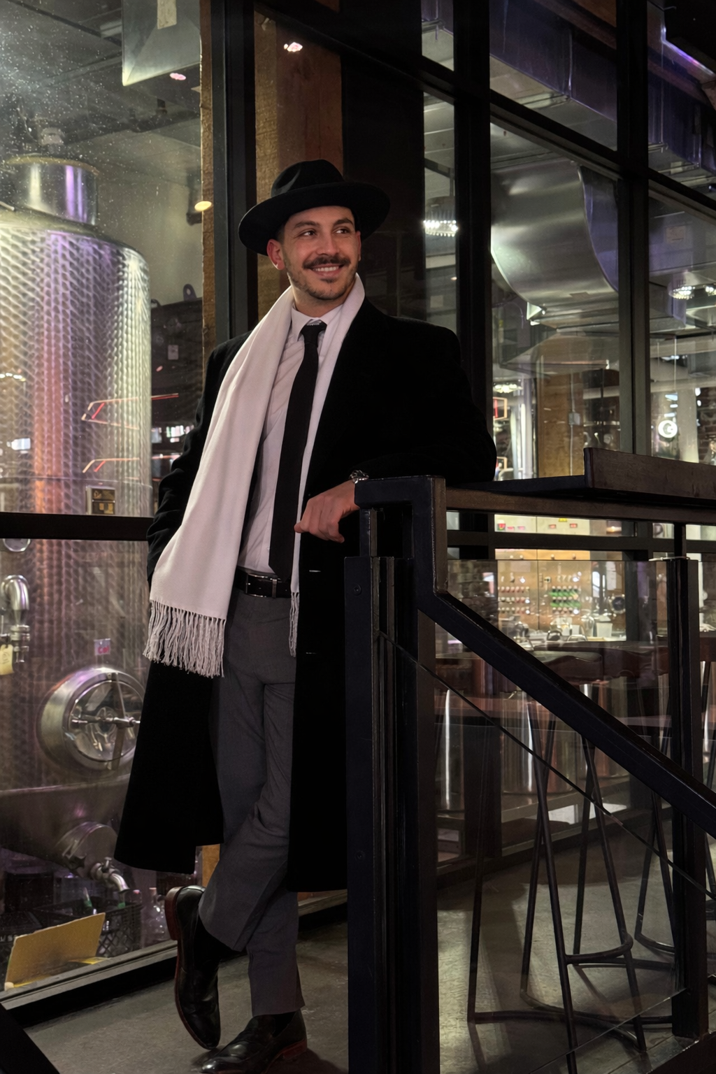 Photo of the Founder of Aurelia Events Company, Luca Arcuri as he stands and smiles inside of Spirit of York within Toronto's historic Distillery District .